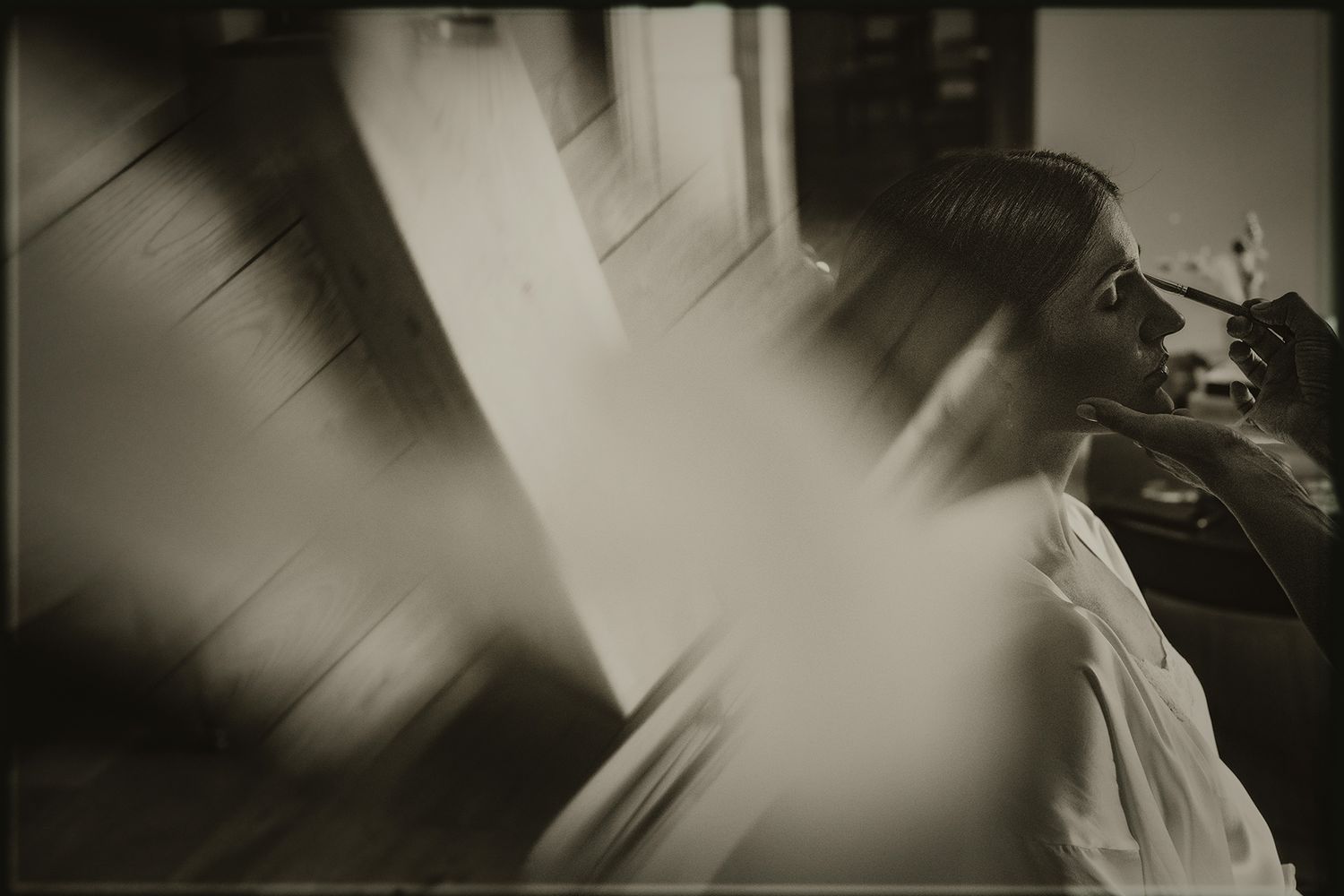 Blurry black and white artistic photograph showing abstract motion blur and shadows in an interior setting.