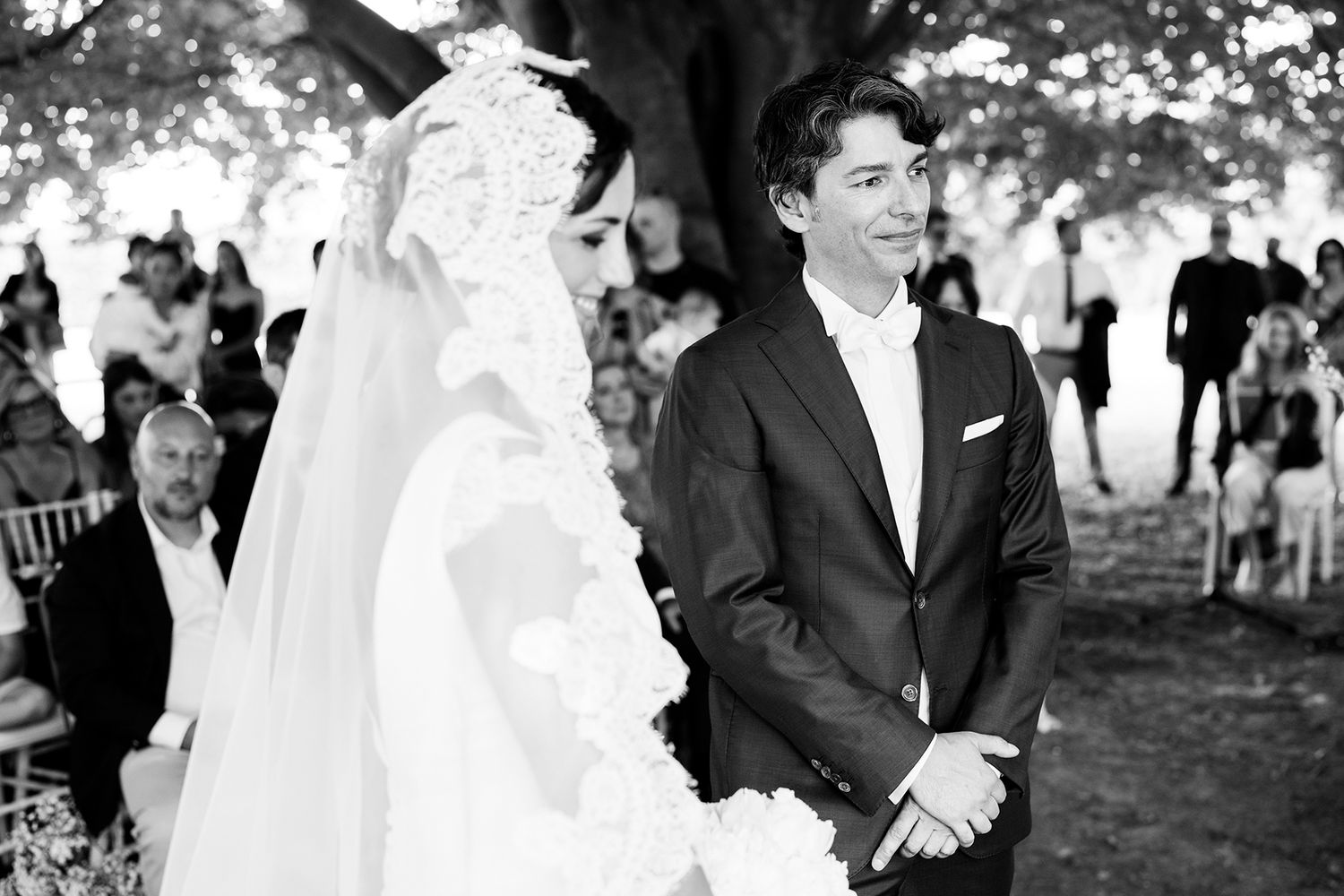 Black and white photos capturing moments from an outdoor wedding ceremony.