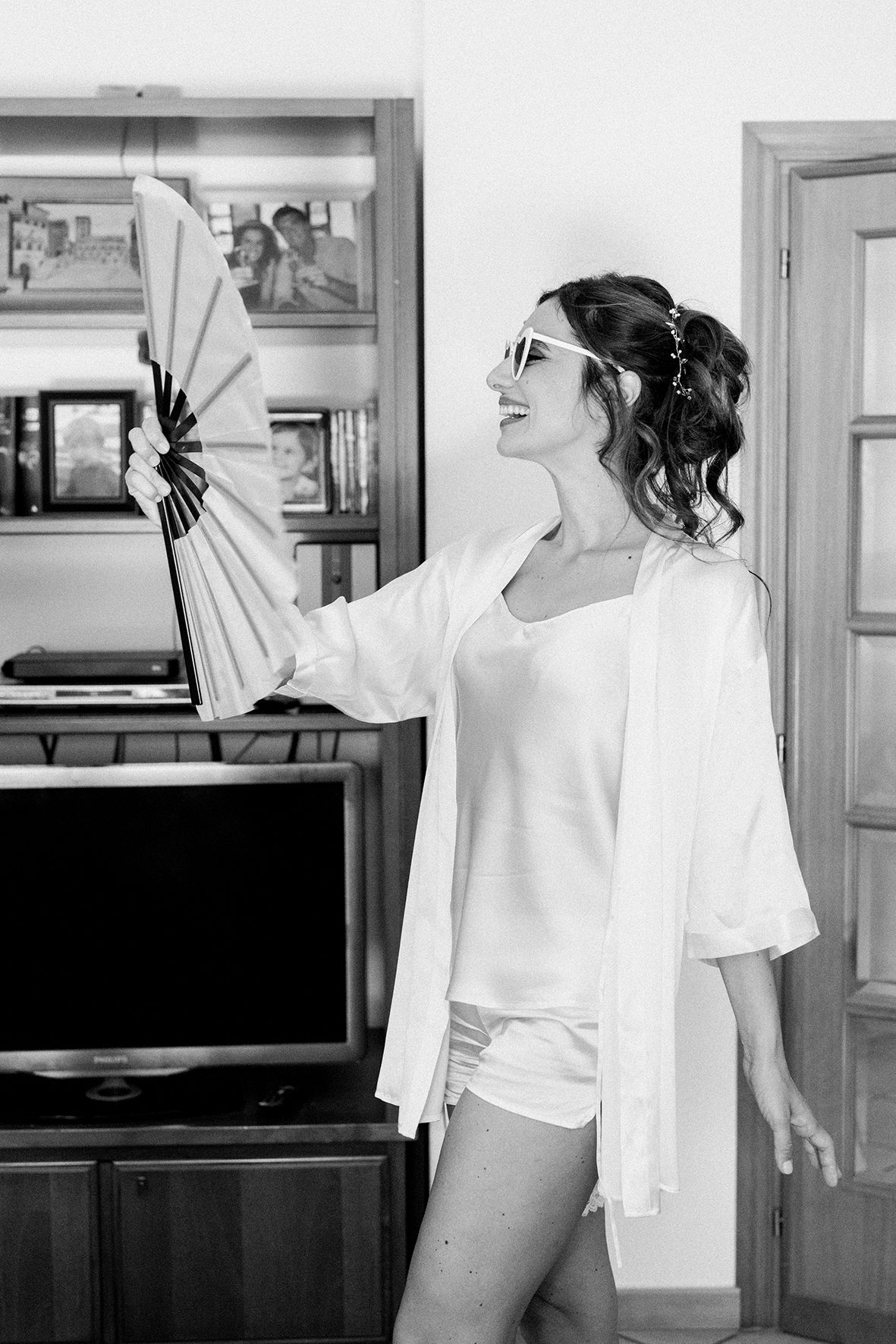 Artistic black and white sequence of someone in a white shirt posing against a wall.