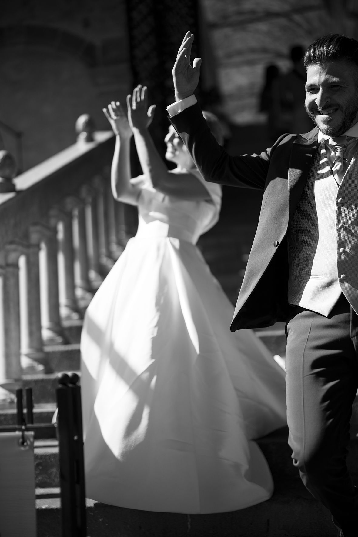Artistic black and white dance sequence under architectural columns.
