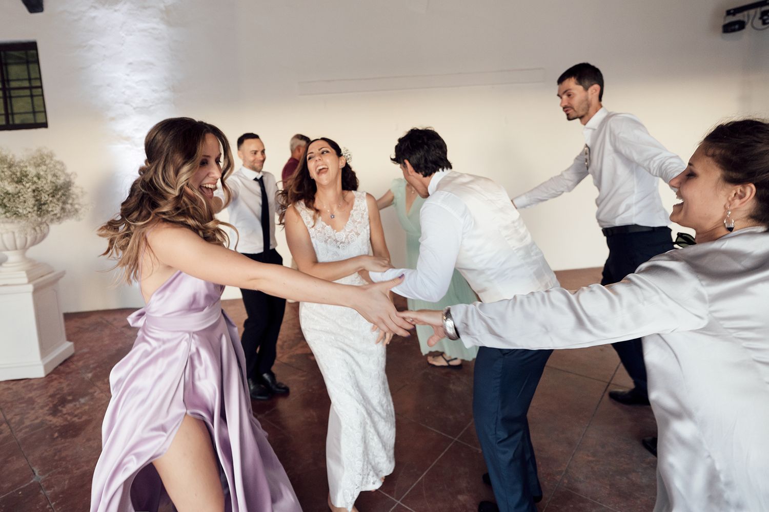 Wedding party performs choreographed dance moves in coordinated outfits.