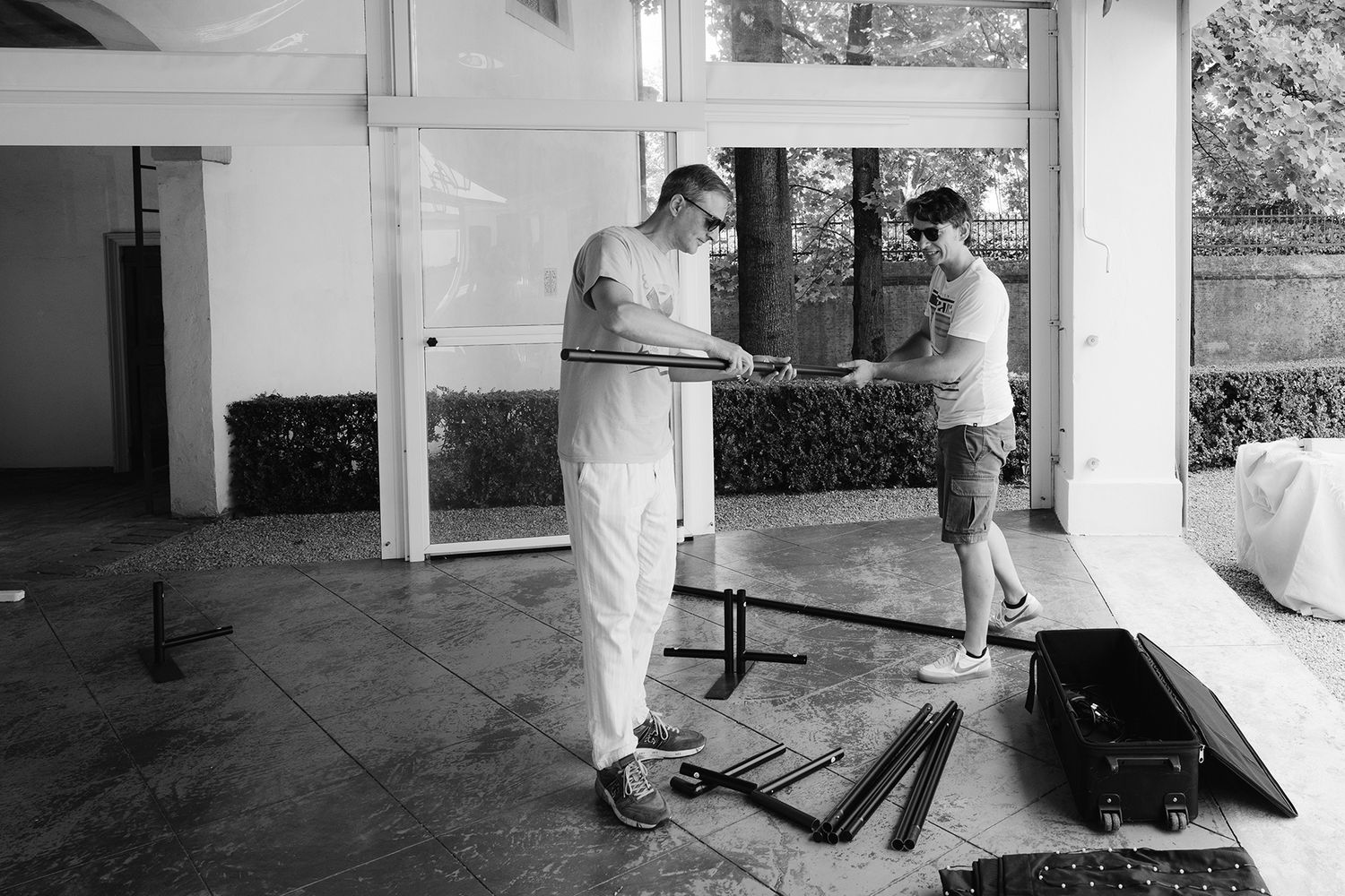 Black and white photo of people working on construction or renovation project.