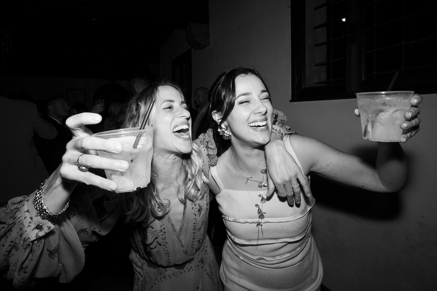 Candid moments of wedding guests dancing and celebrating at a lively reception.
