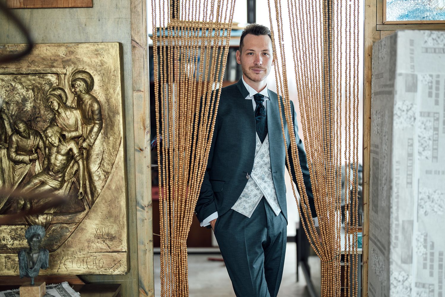 A formal portrait session in a rustic venue with wooden slat walls and vintage decor.