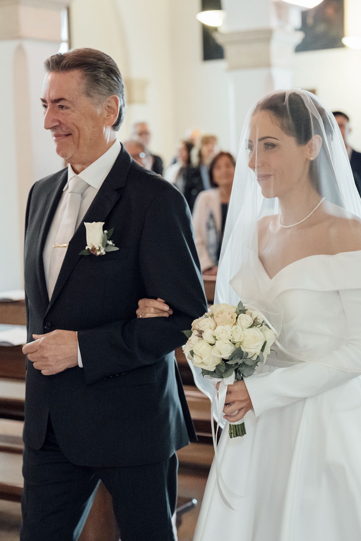 Intimate wedding ceremony moments inside a bright church with classic architectural details.