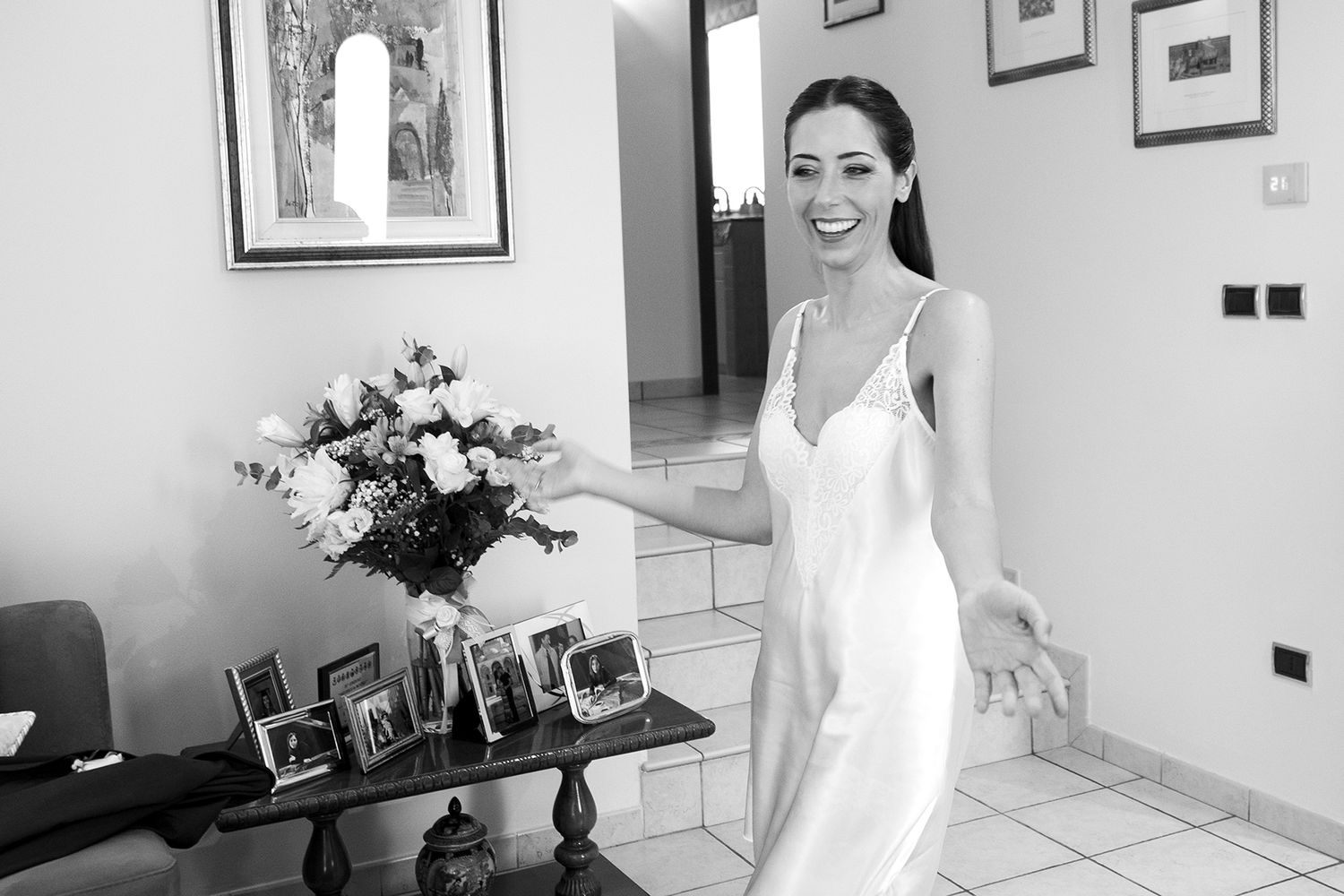 Bright interior room with white decor and floral arrangements.