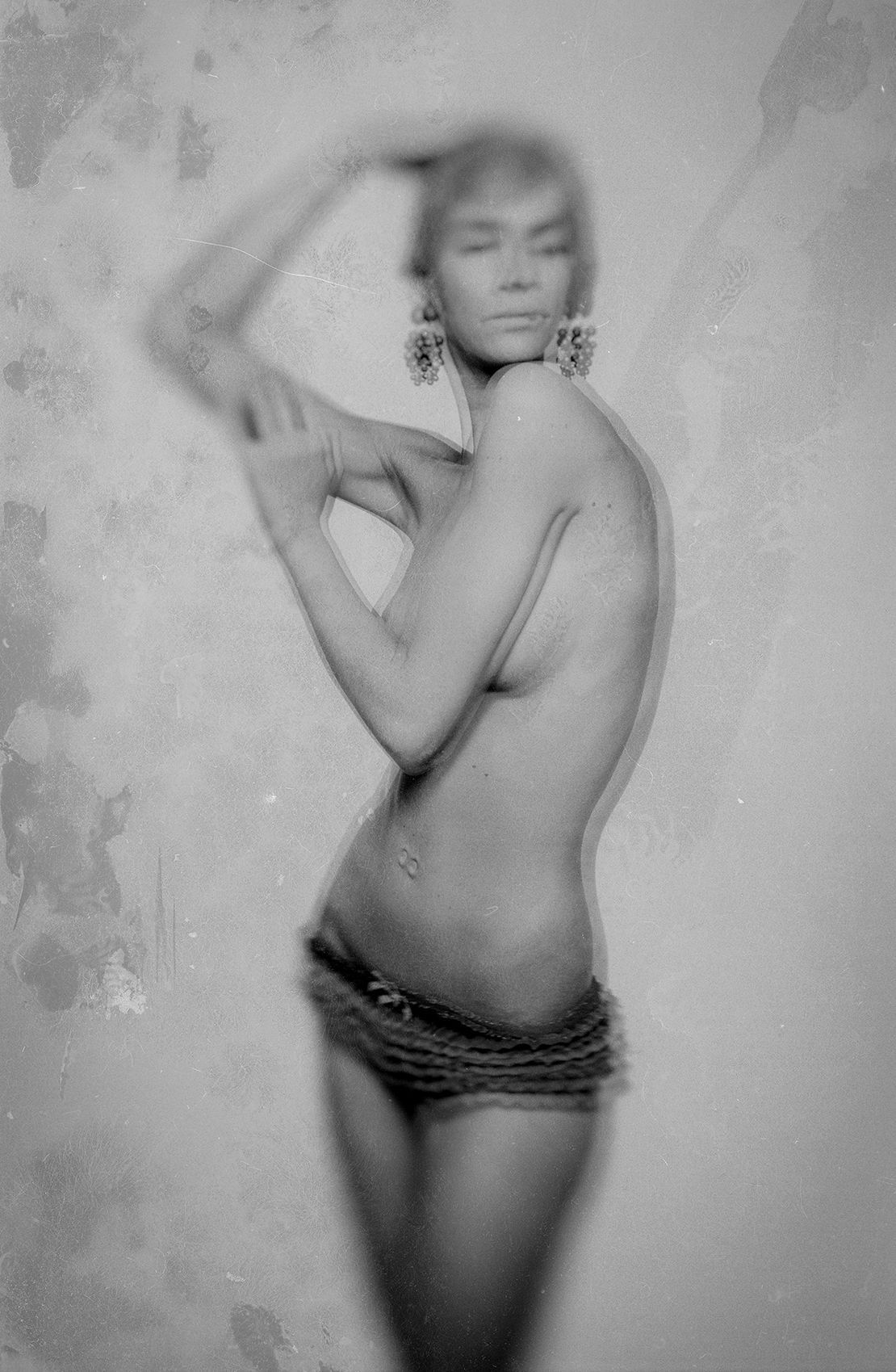 Vintage style black and white boudoir portrait with artistic blur effect.