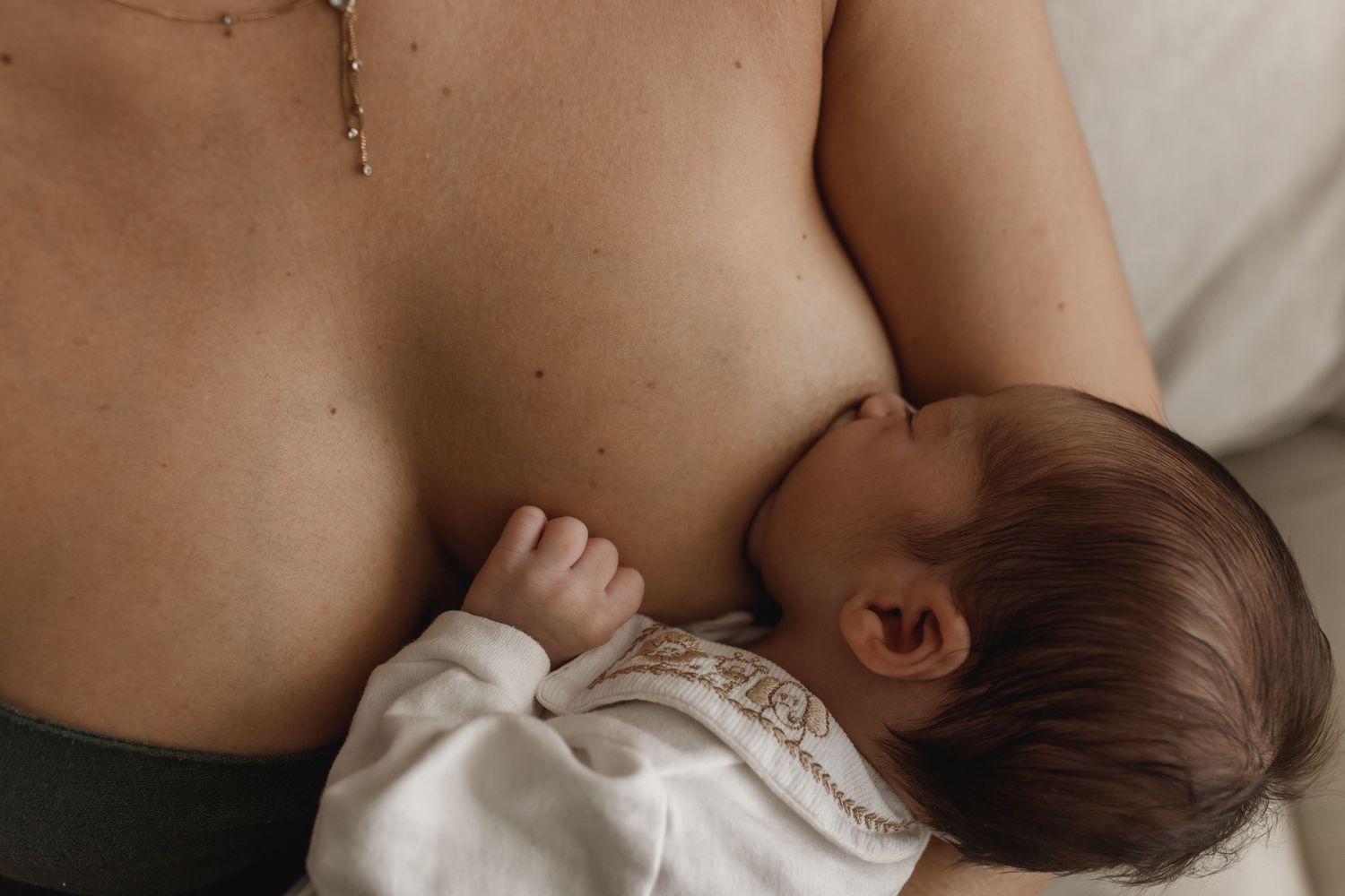 Tender nursing session photographed in gentle morning light.