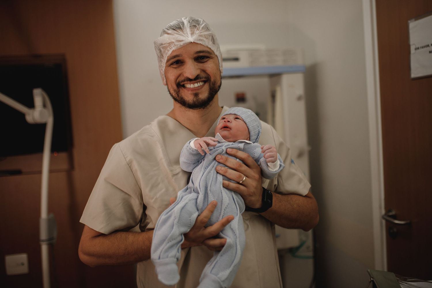 A tender moment in a hospital room as medical staff care for a newborn baby.