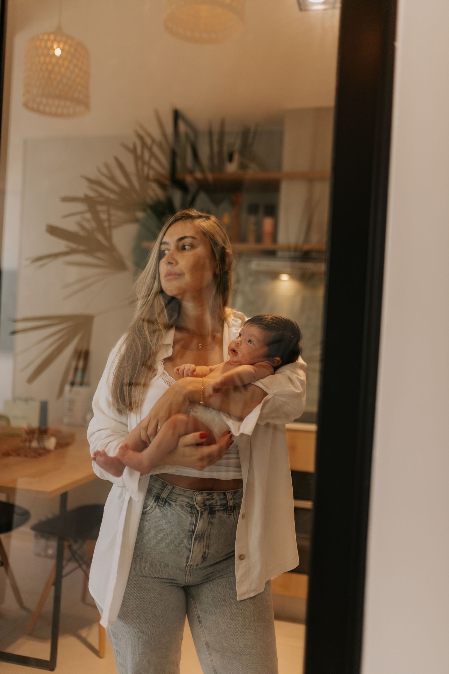 Family lifestyle session in modern home with natural light streaming through windows.