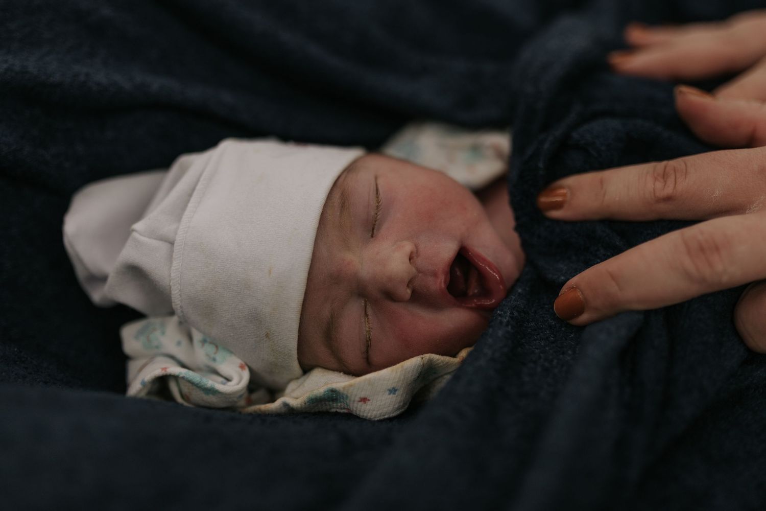 Hands holding mobile devices to document a special moment in the hospital.