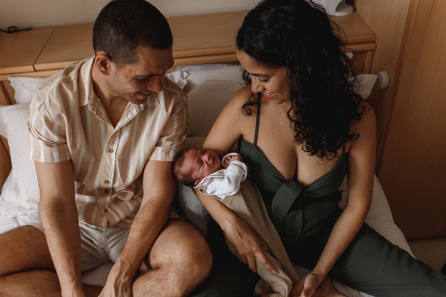Intimate family moment captured in warm tones on a comfortable couch.
