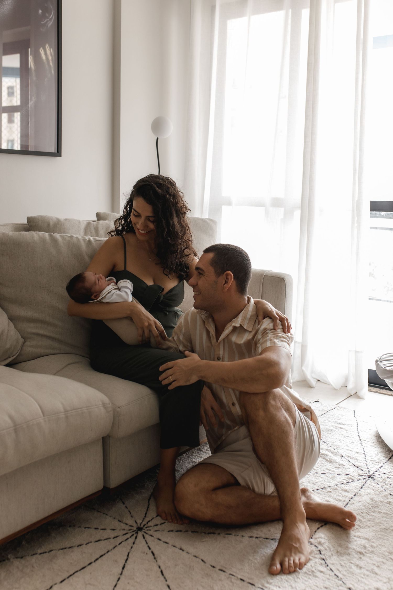 Lifestyle family session showing tender moments on living room floor.
