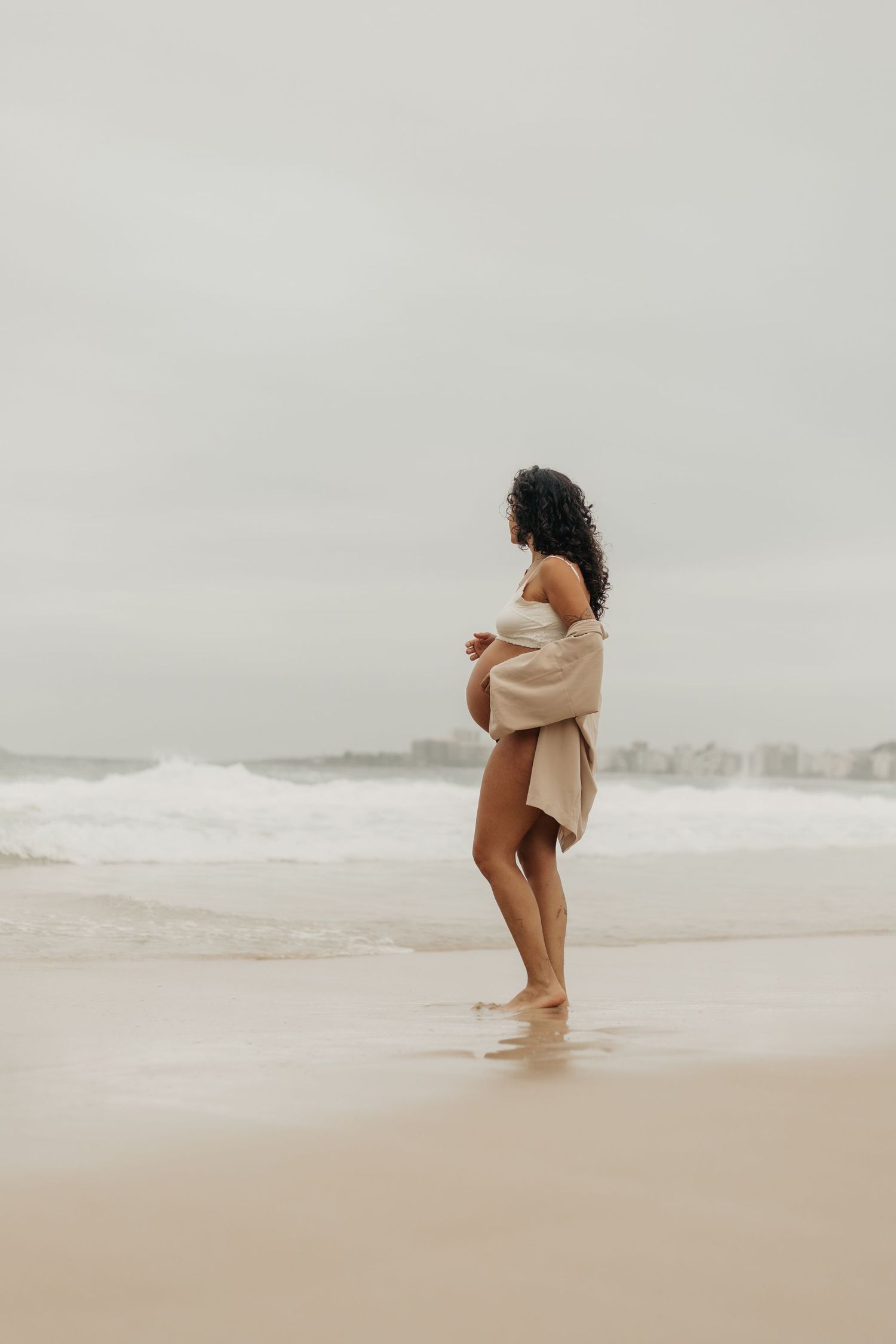 Minimalist beach photography sequence showing a person walking into ocean waves.