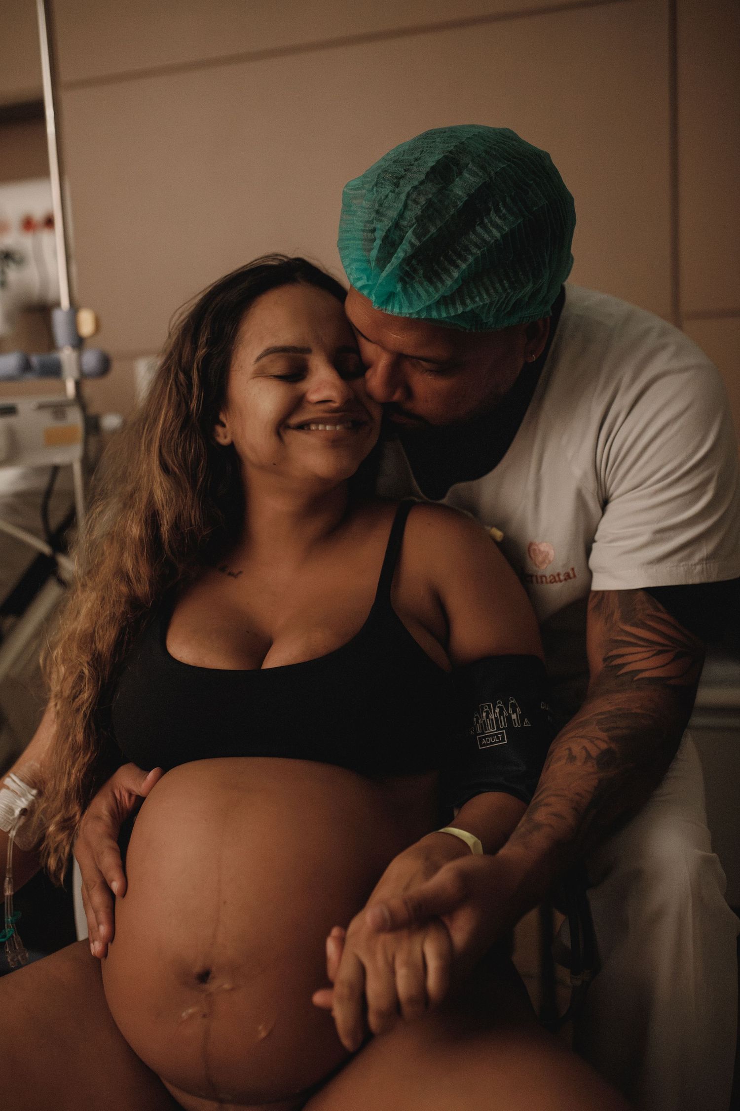 A maternity scene in a hospital room with medical staff in scrubs.