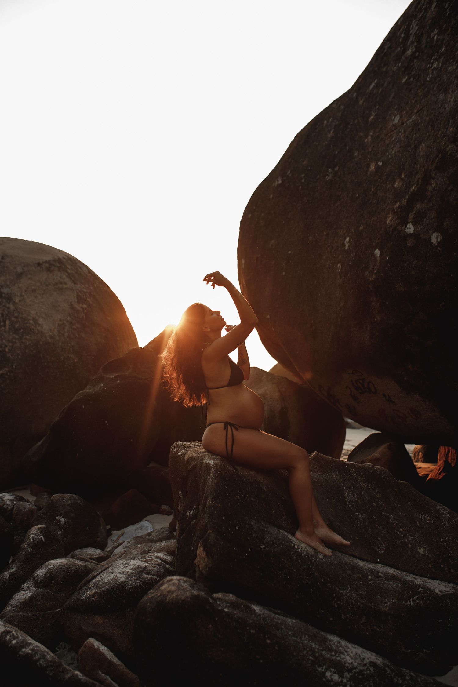 Silhouette photography on rocky beach during golden hour sunset.