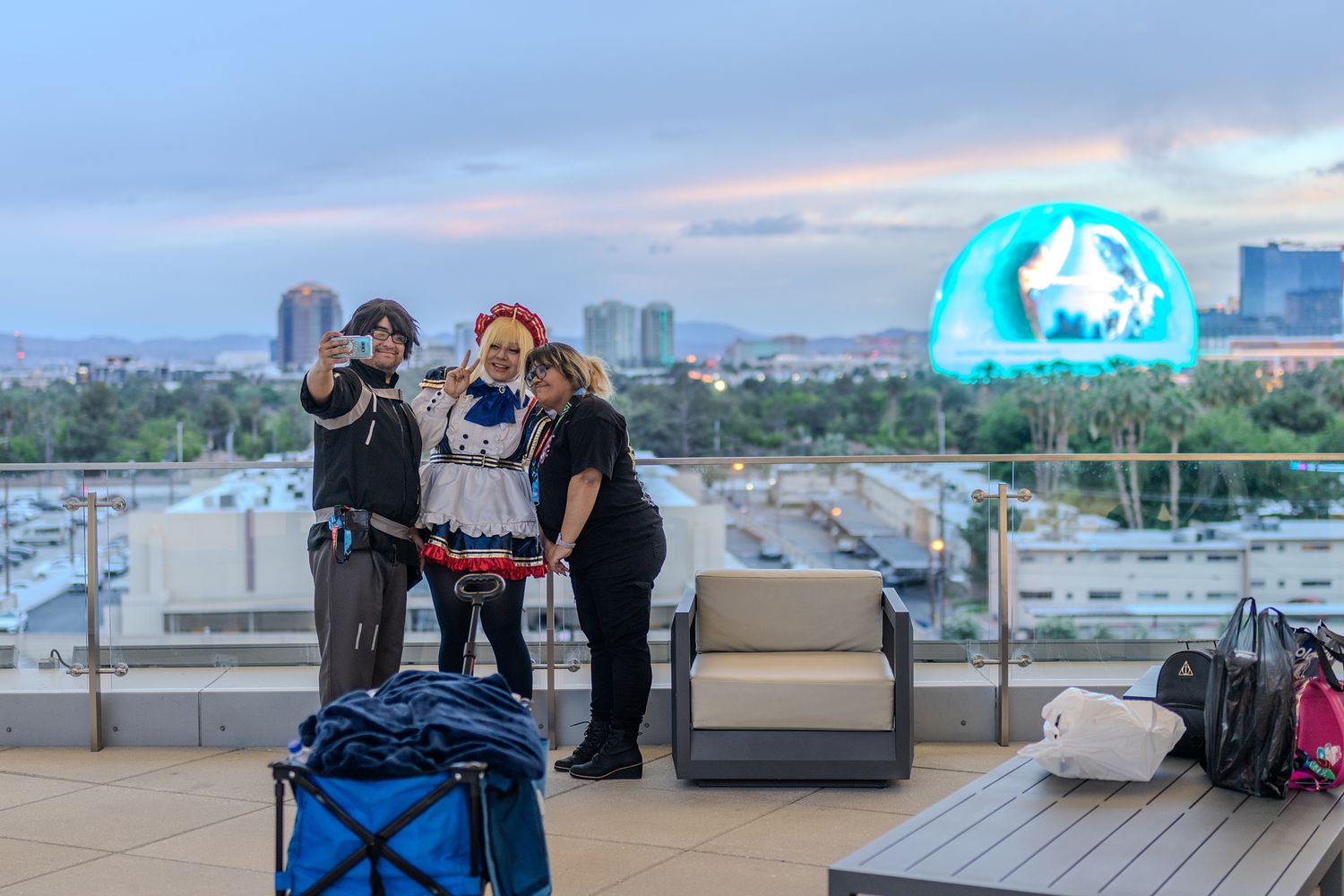 Urban rooftop scene with city skyline and people gathering in evening light.