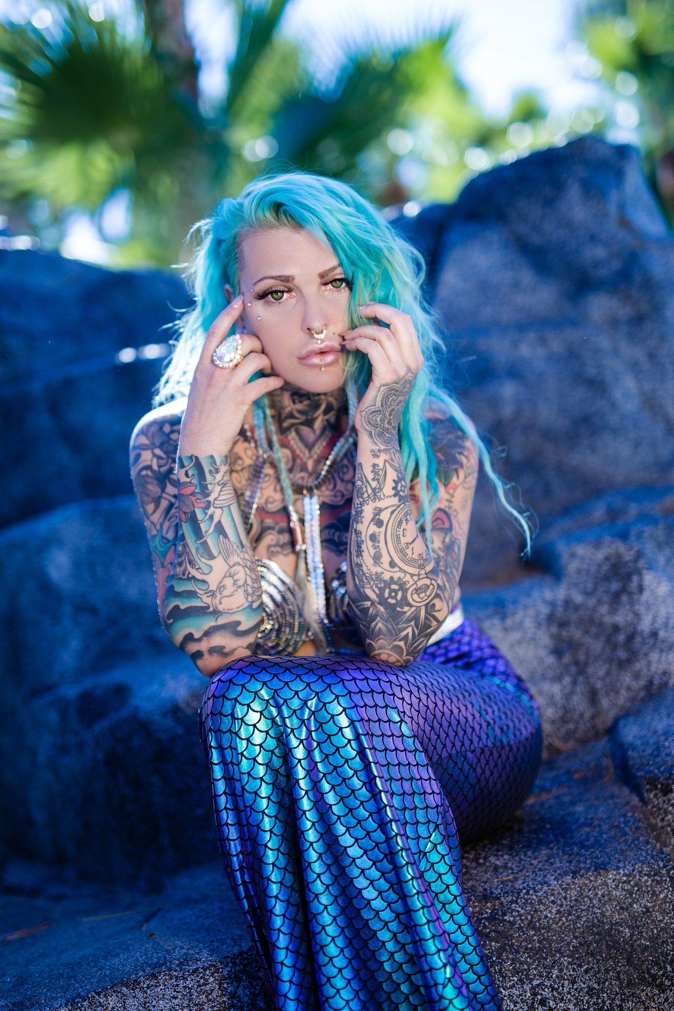 Mermaid-inspired photoshoot with iridescent scales and blue tones.