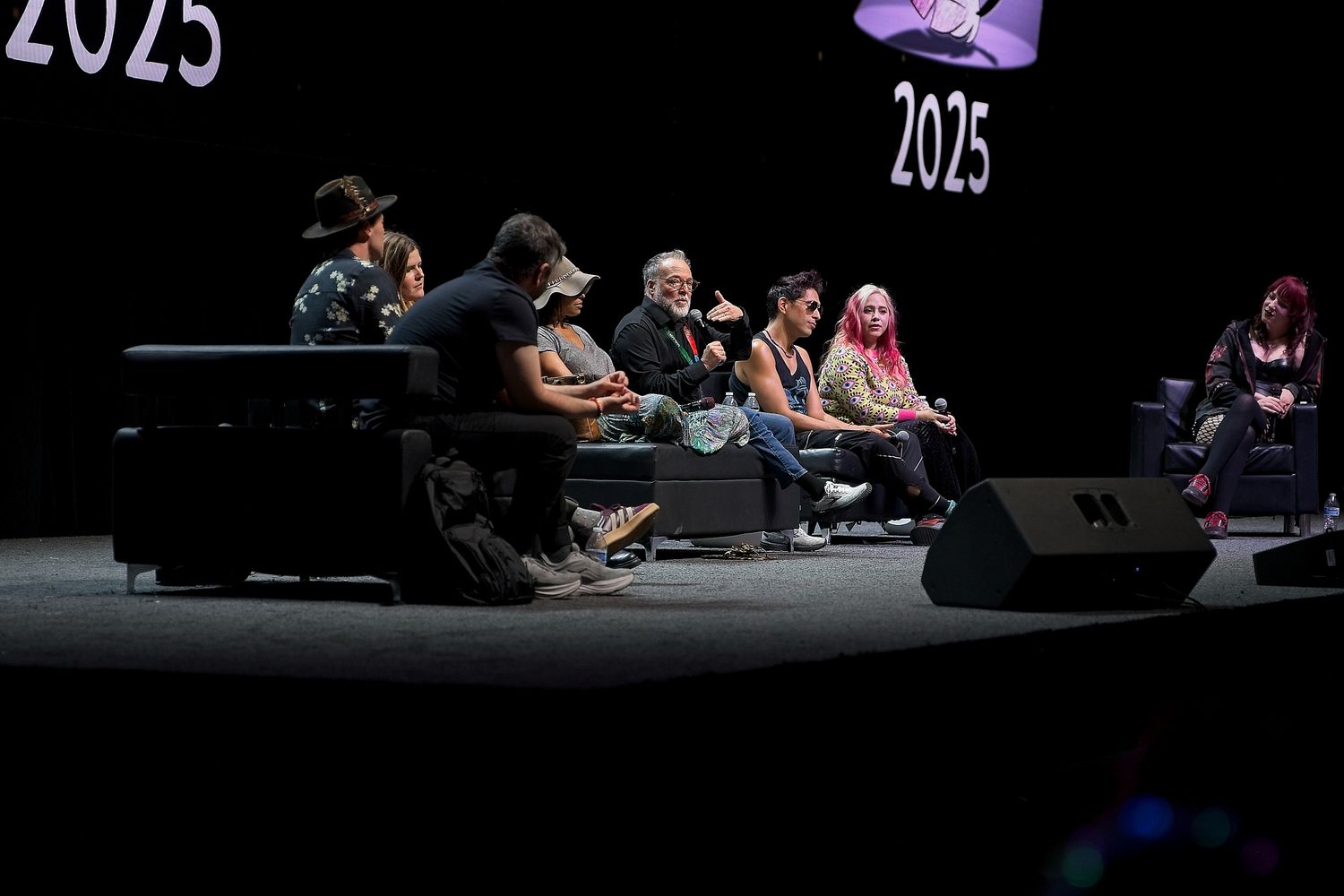 Conference stage setup with '2025' text displayed against a dark background.