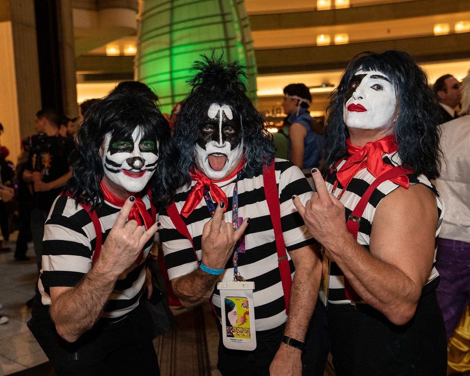 Group wearing KISS-style makeup and costumes performing at an event.
