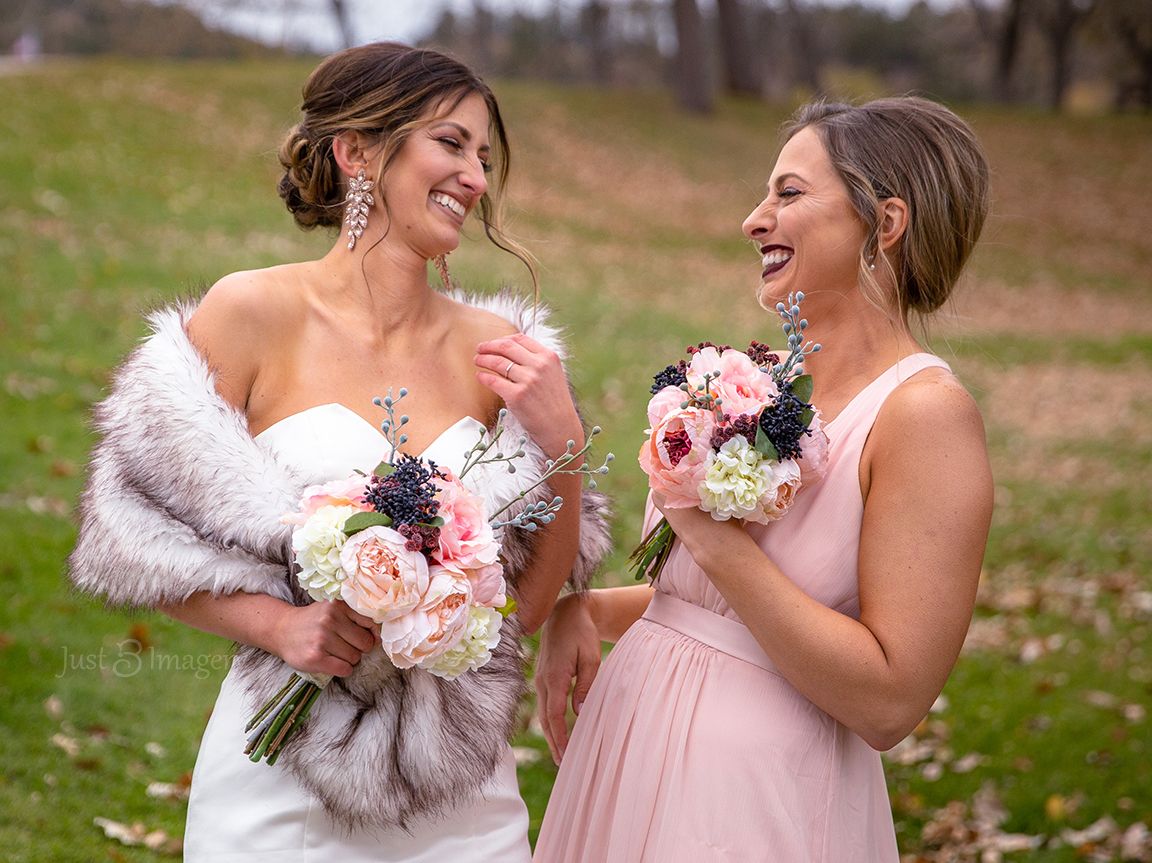 bride and maid of honor laughing at each other