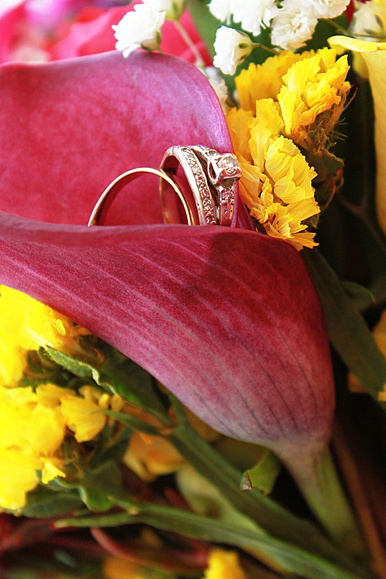wedding rings sitting in bouquet with pink Cala Lilly and yellow accent flowers