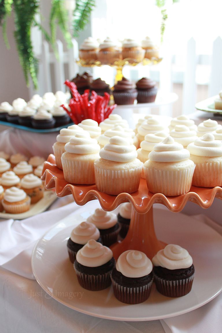 tiers of cupcakes on display at wedding ceremony