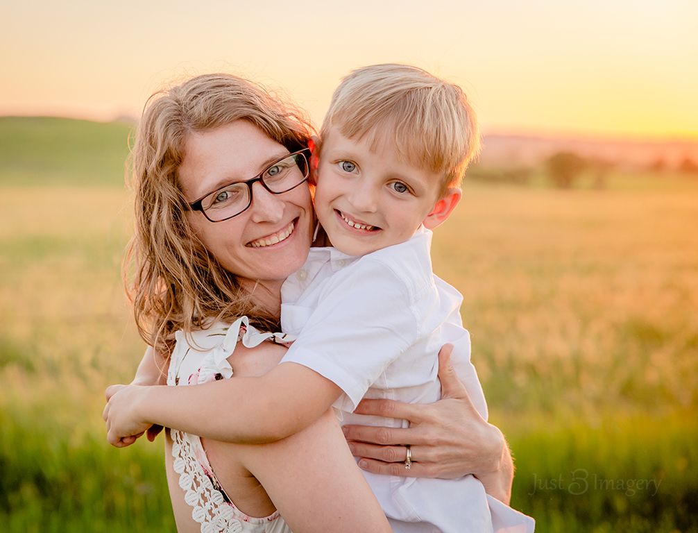 mom and young son in glowy field, sunny portrait, sunset