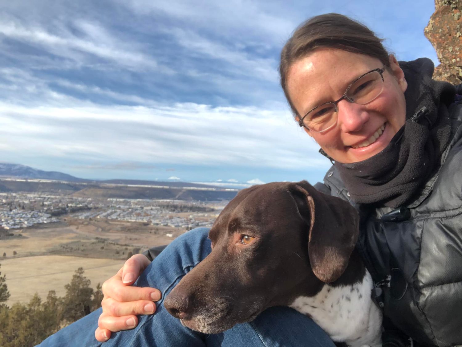 Brooke Coshow at the top of Barnes Butte with her dog