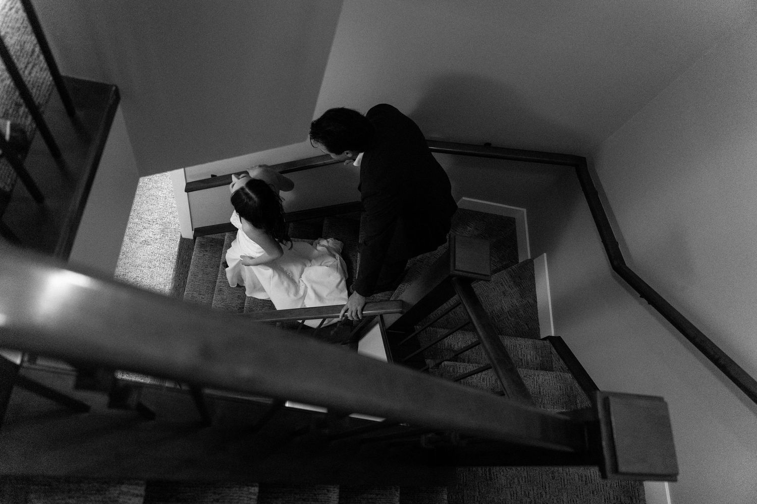 A black and white photo sequence shows someone working at a desk with multiple computer monitors in a dark room.