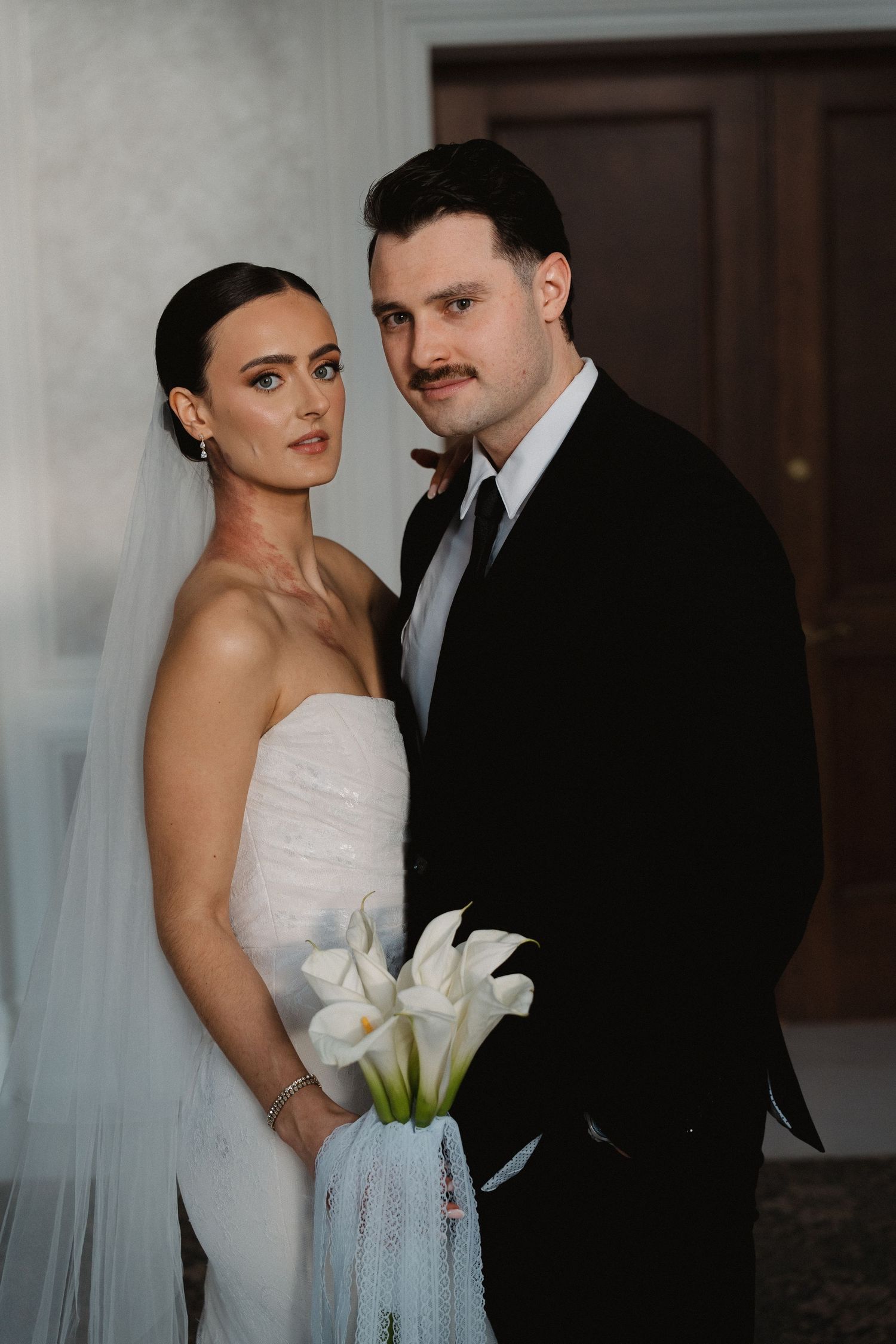 A romantic wedding portrait series showing a couple in formal attire with white calla lily bouquet against a soft background.