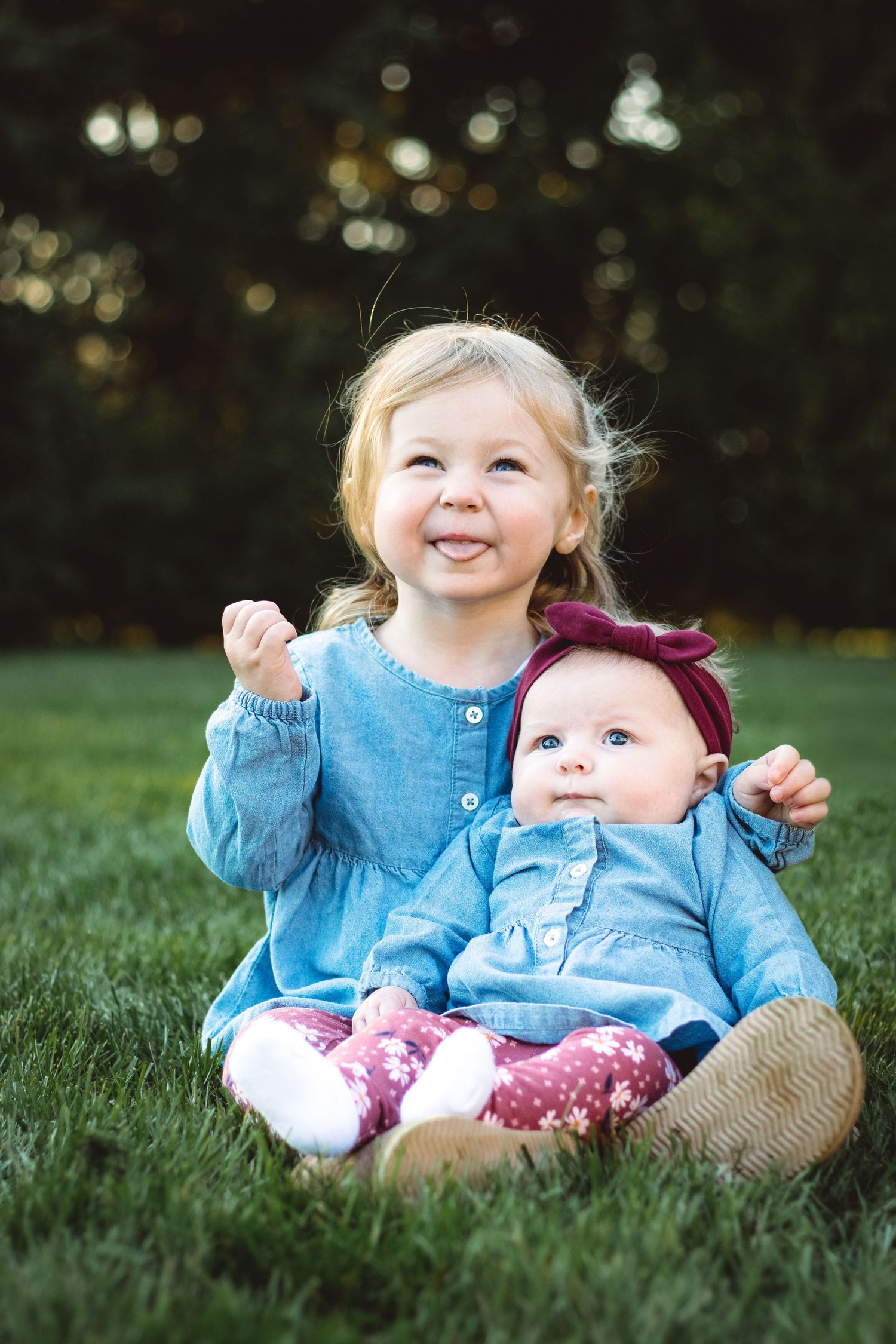 Toddler holding baby sister with big happy smile, Metro Detroit family photography, Sam Jackson Photography, Joyful Family Photography.