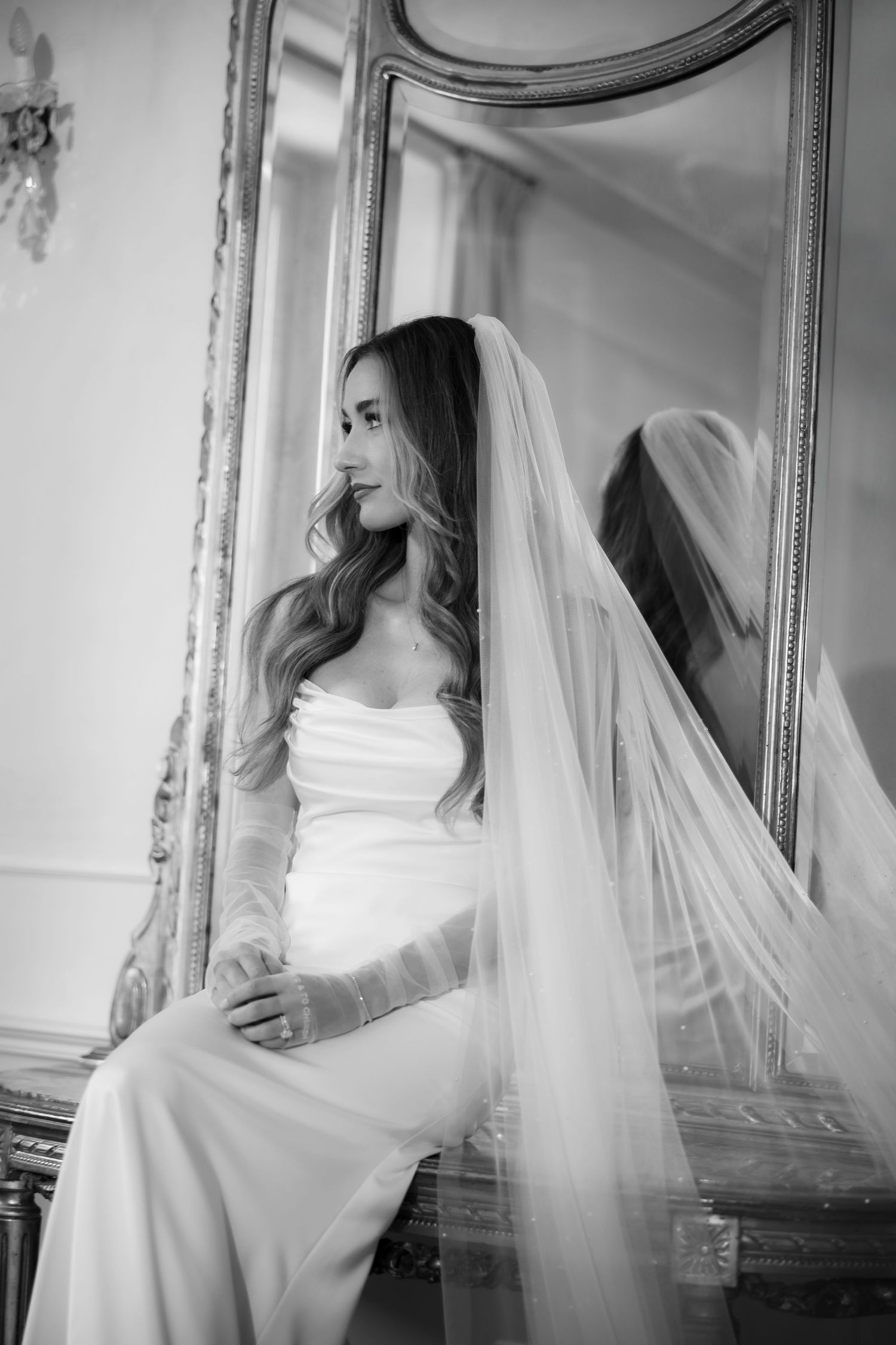 Black and white portrait of the bride with dramatic natural light and cinematic composition.