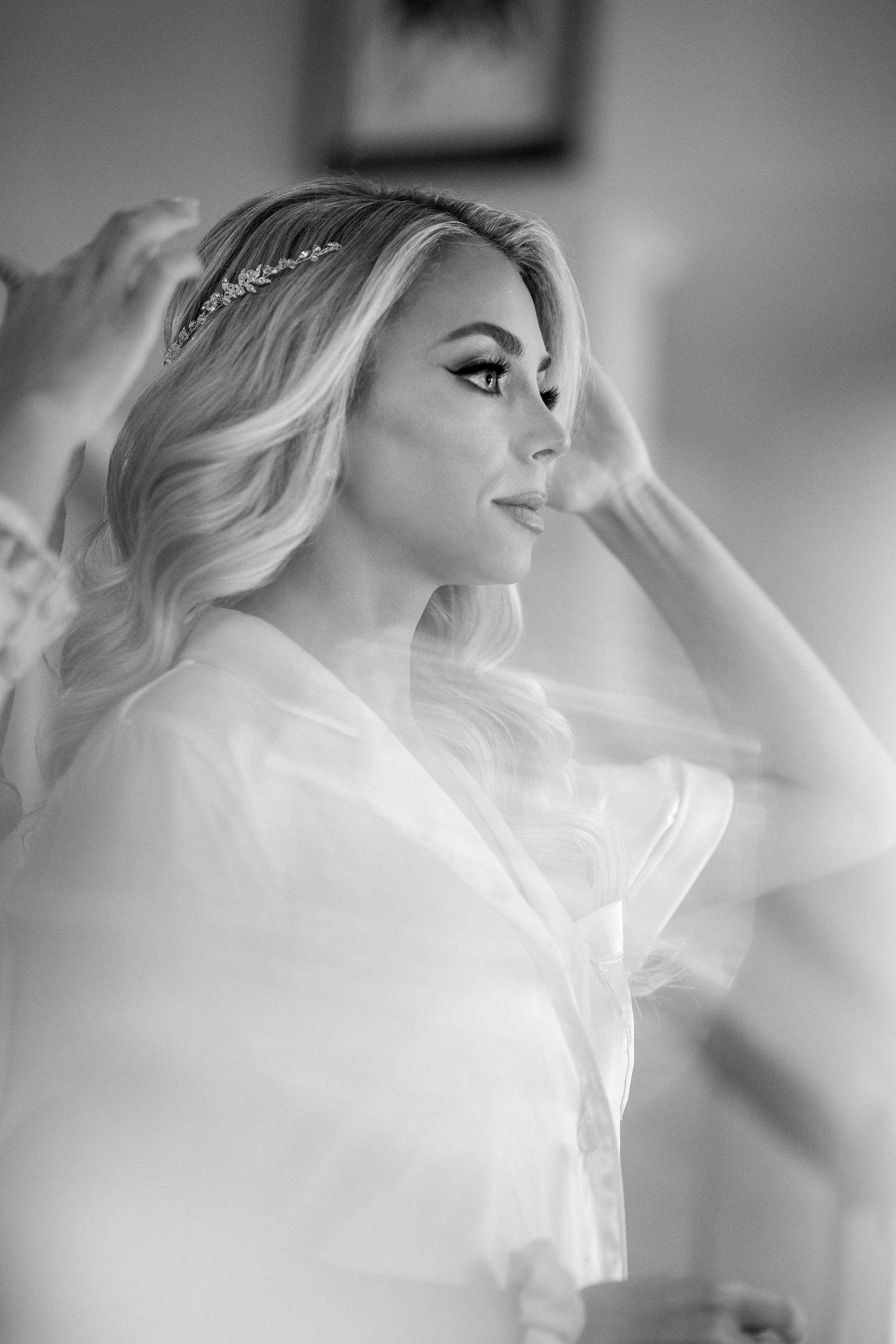 Black and white portrait of bride getting ready with delicate hair details.