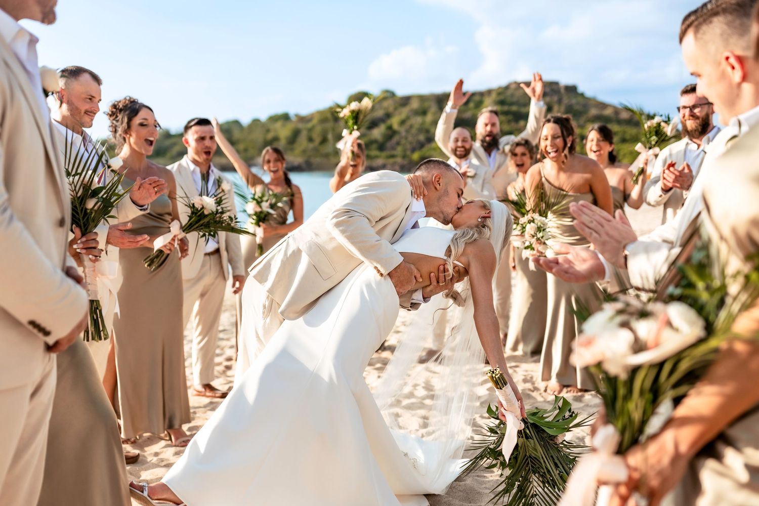 Joyful beach ceremony surrounded by guests during a tropical destination wedding in Antigua.