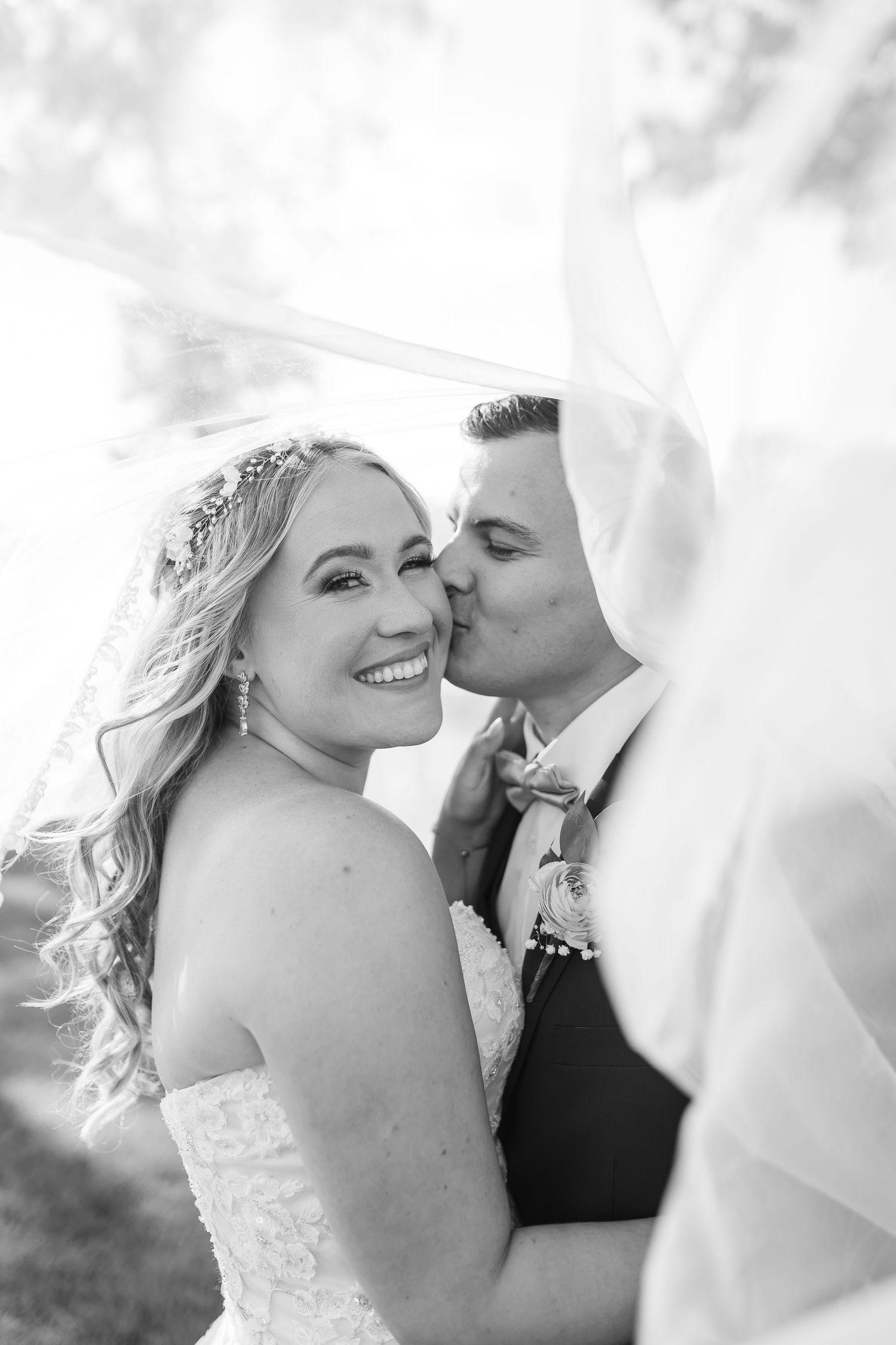 Black and white romantic wedding photos showing tender moments between newlyweds in intimate close-up shots.