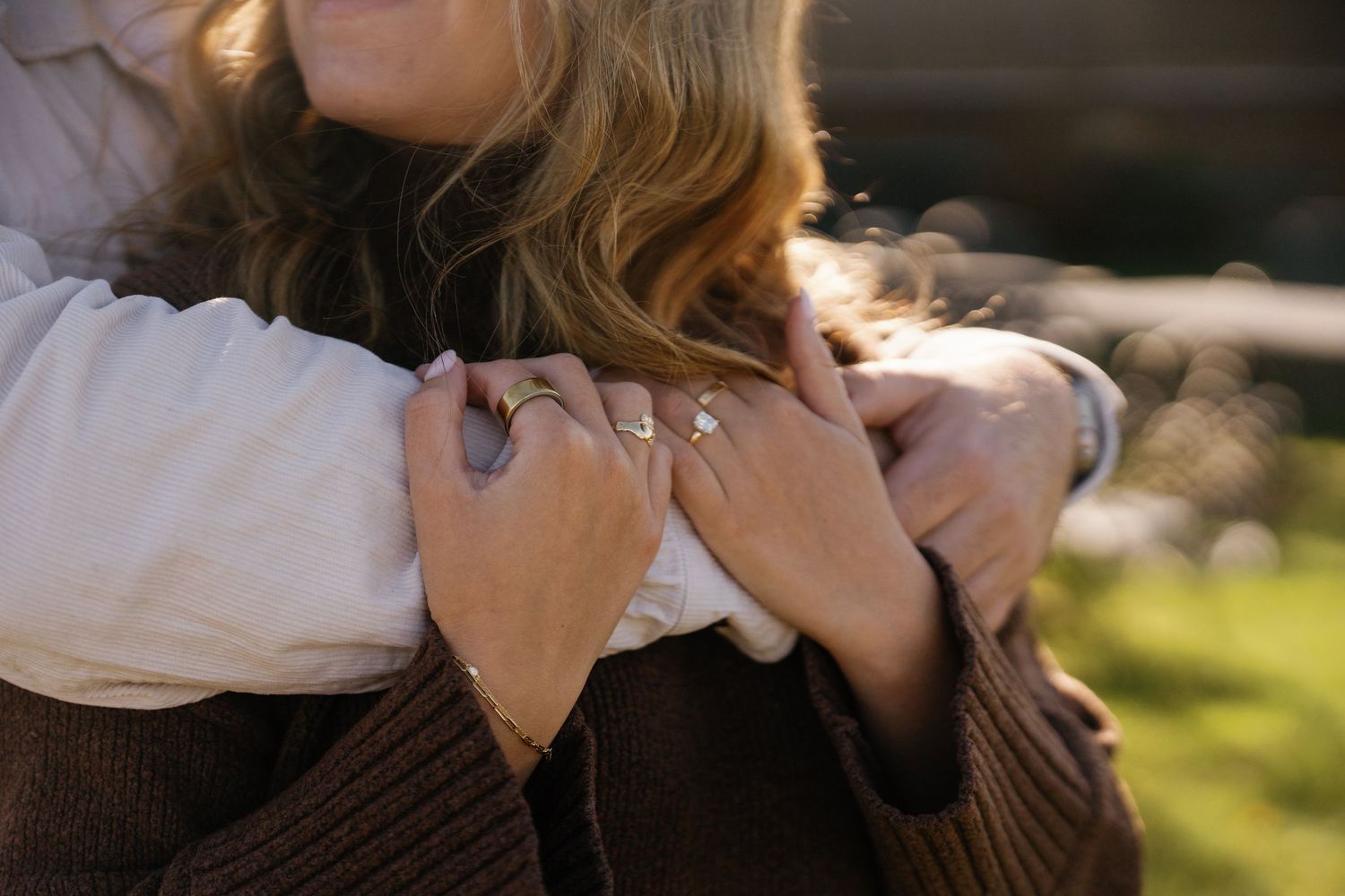 A sequence of close-up shots showing hands holding and operating a vintage film camera in outdoor sunlight.