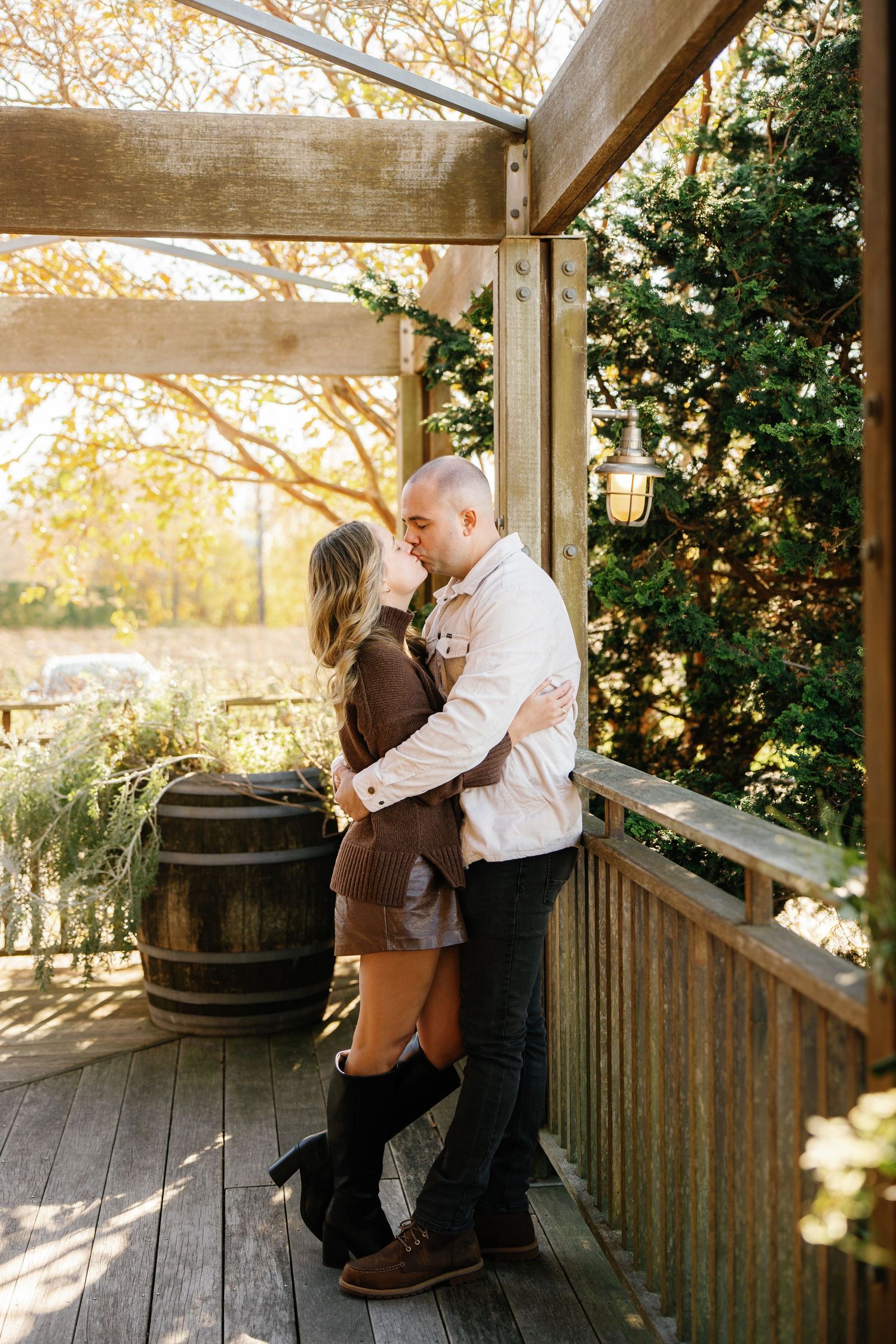 A romantic engagement photoshoot sequence on a rustic wooden porch during golden hour.