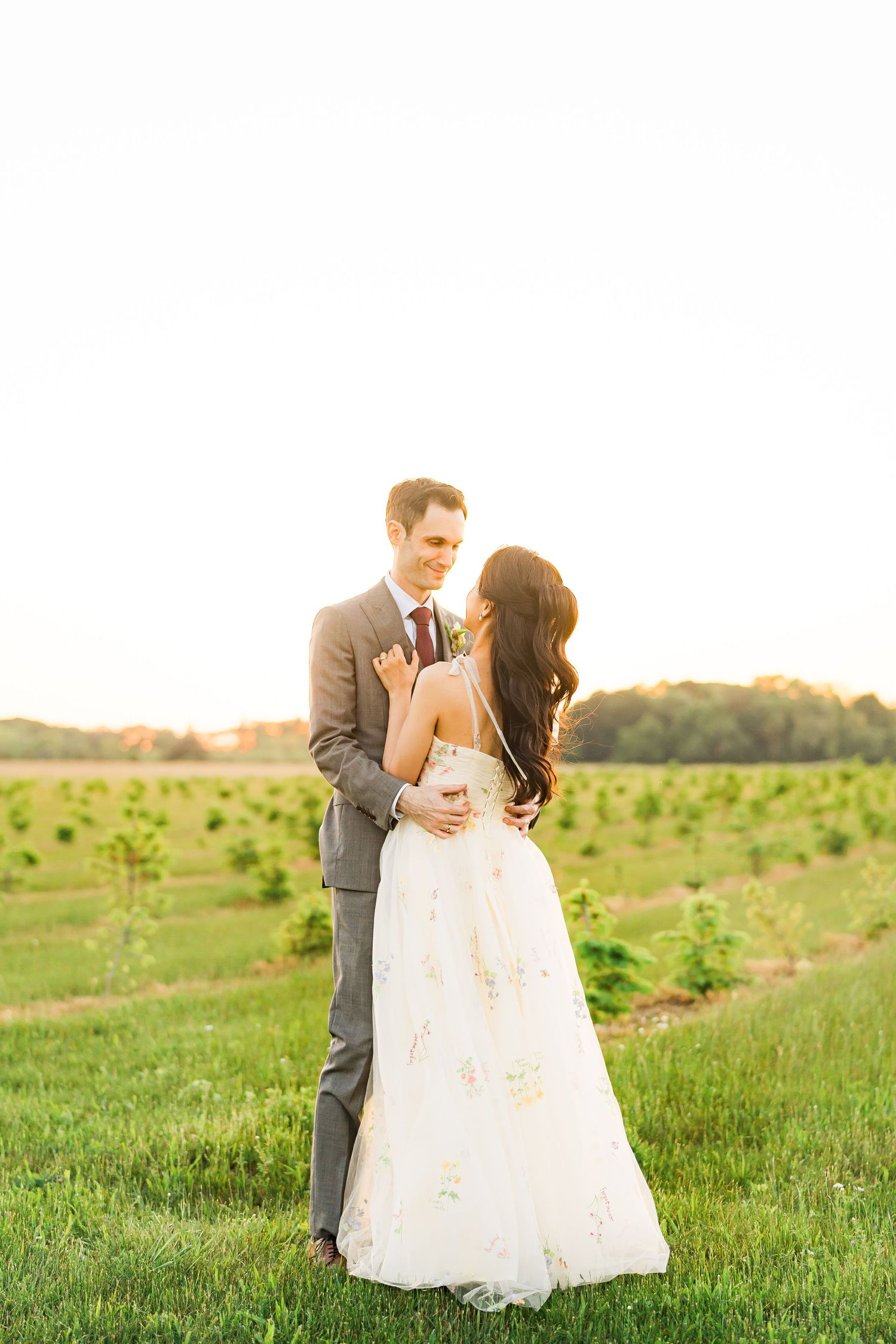 Bride and groom pose in vineyard at Long Island wedding