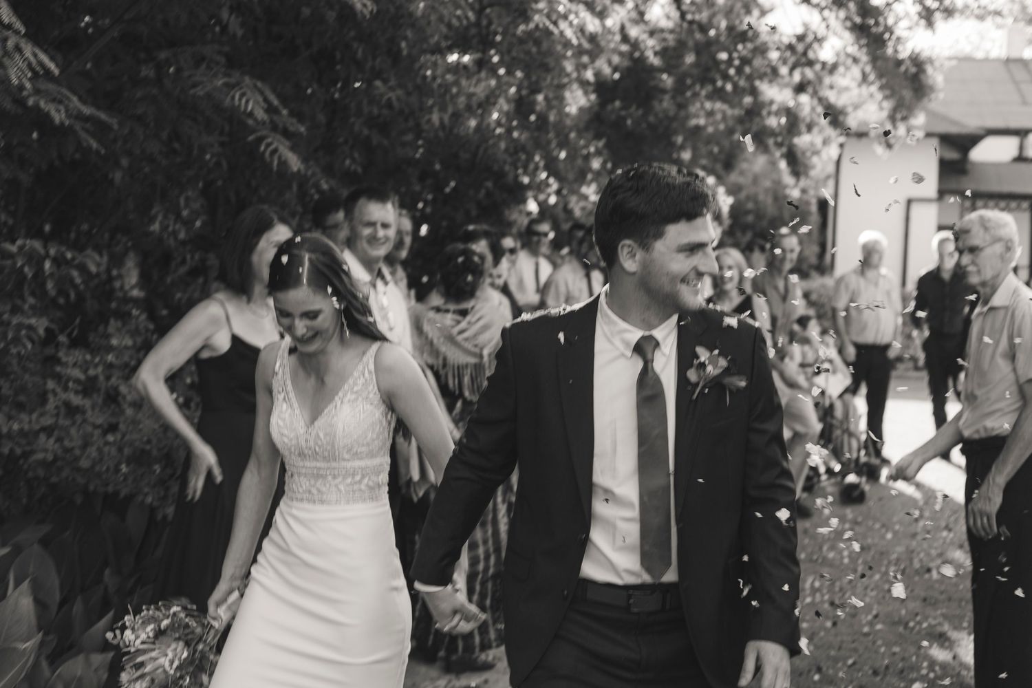 A joyful wedding celebration moment captured in black and white photography.