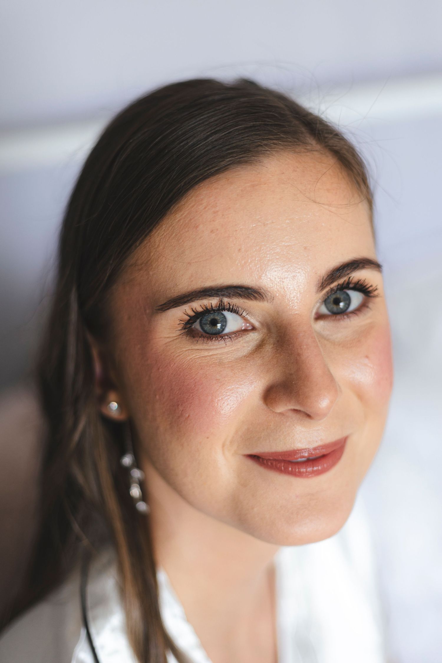 Close up beauty portrait with natural makeup and pearl earrings.
