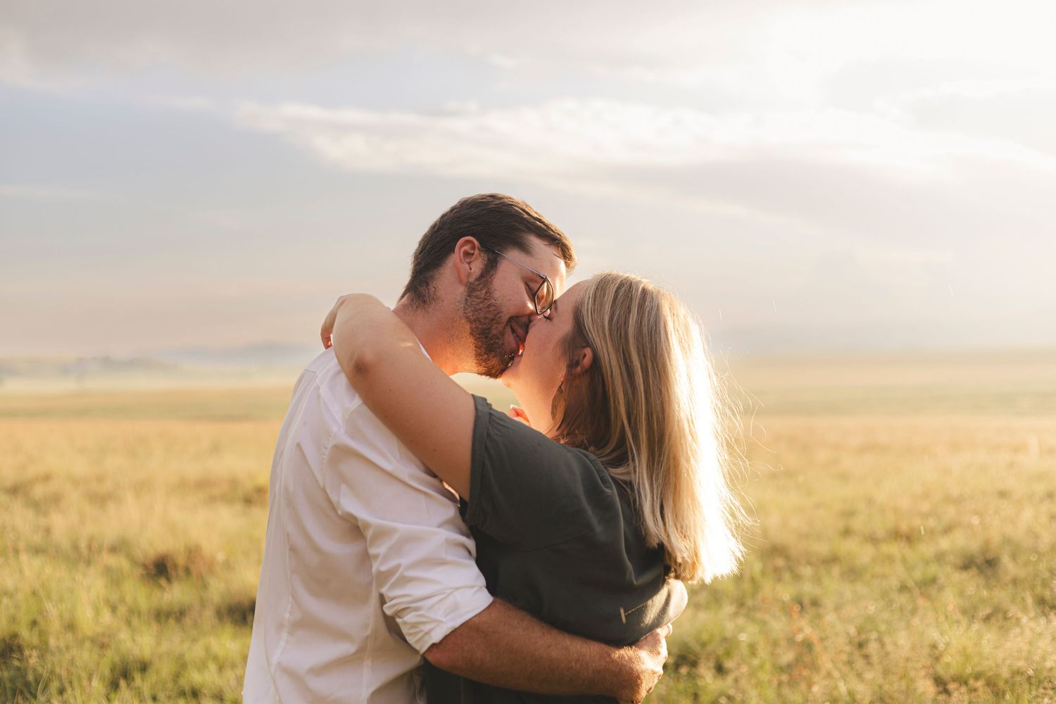 Intimate couple embrace during golden hour photo session.