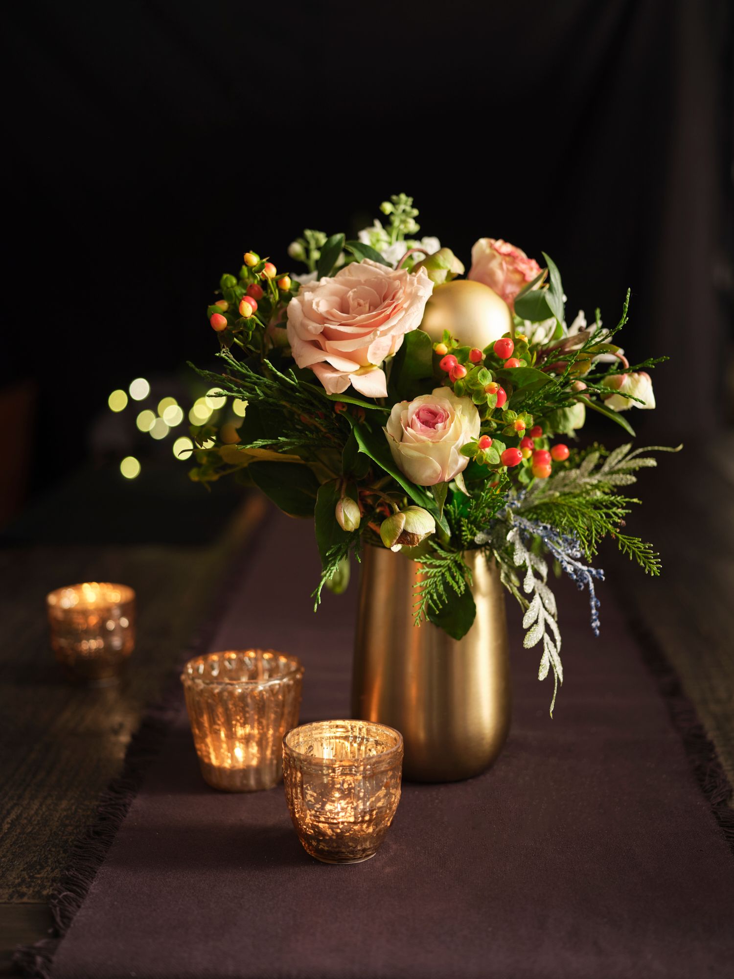 Vase of flowers in a moody atmospheric environment with spots of light in the background