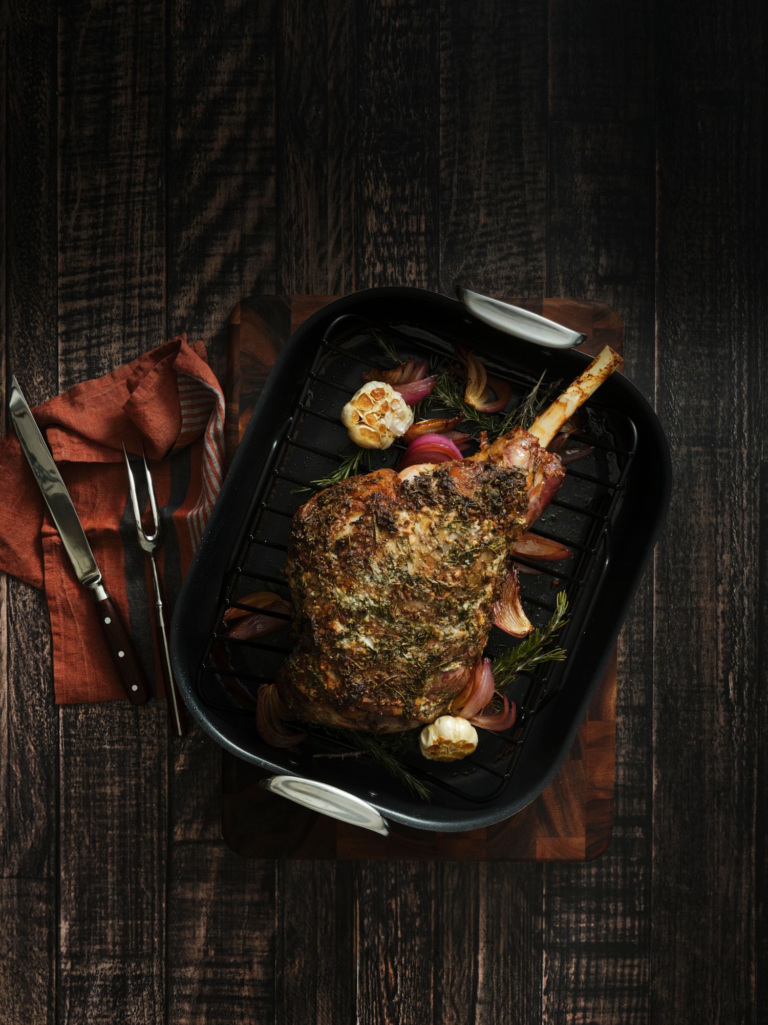 Lamb shank with herbs on a dark table background