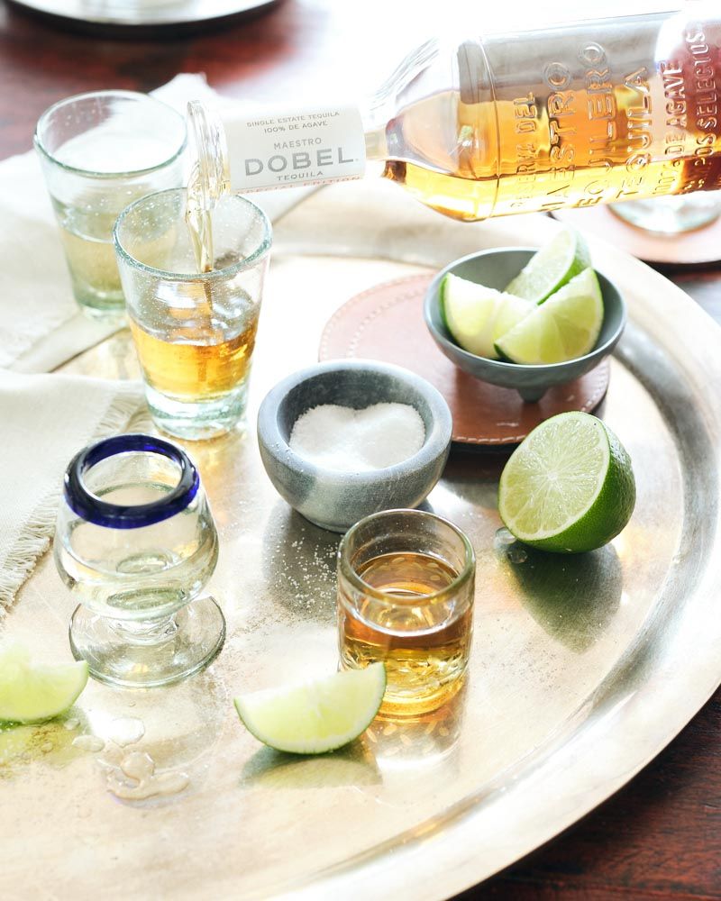 Silver tray with tequila, limes, and salt