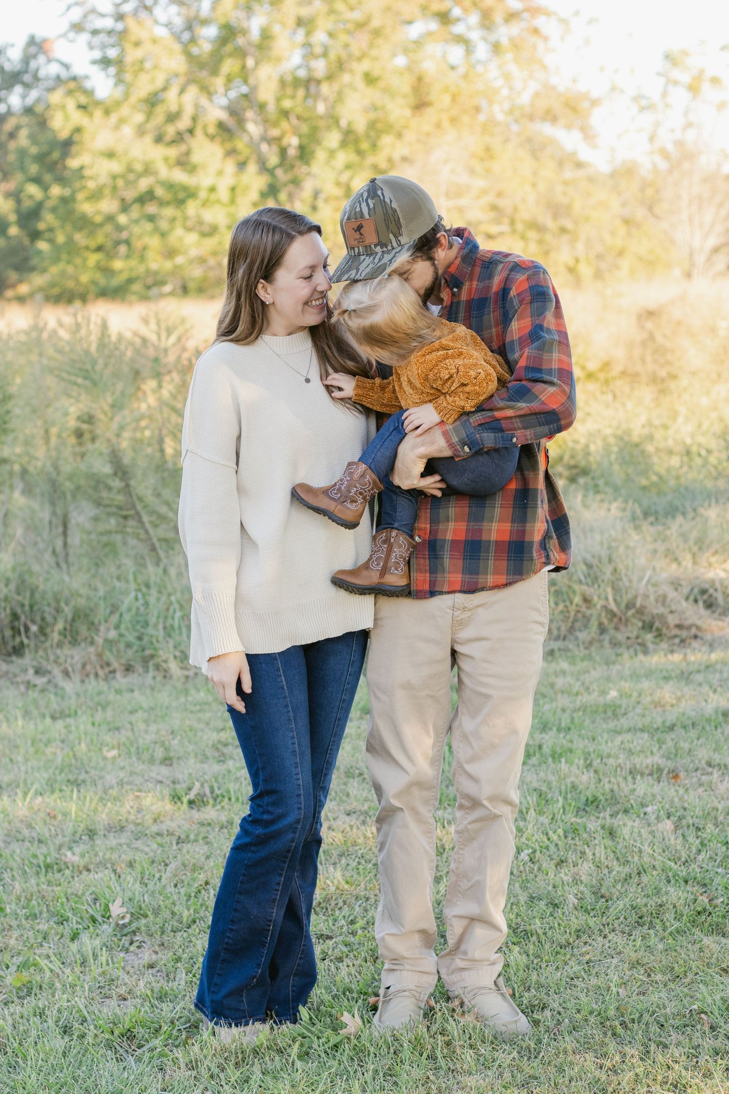Family sharing playful moment together in outdoor autumn setting.