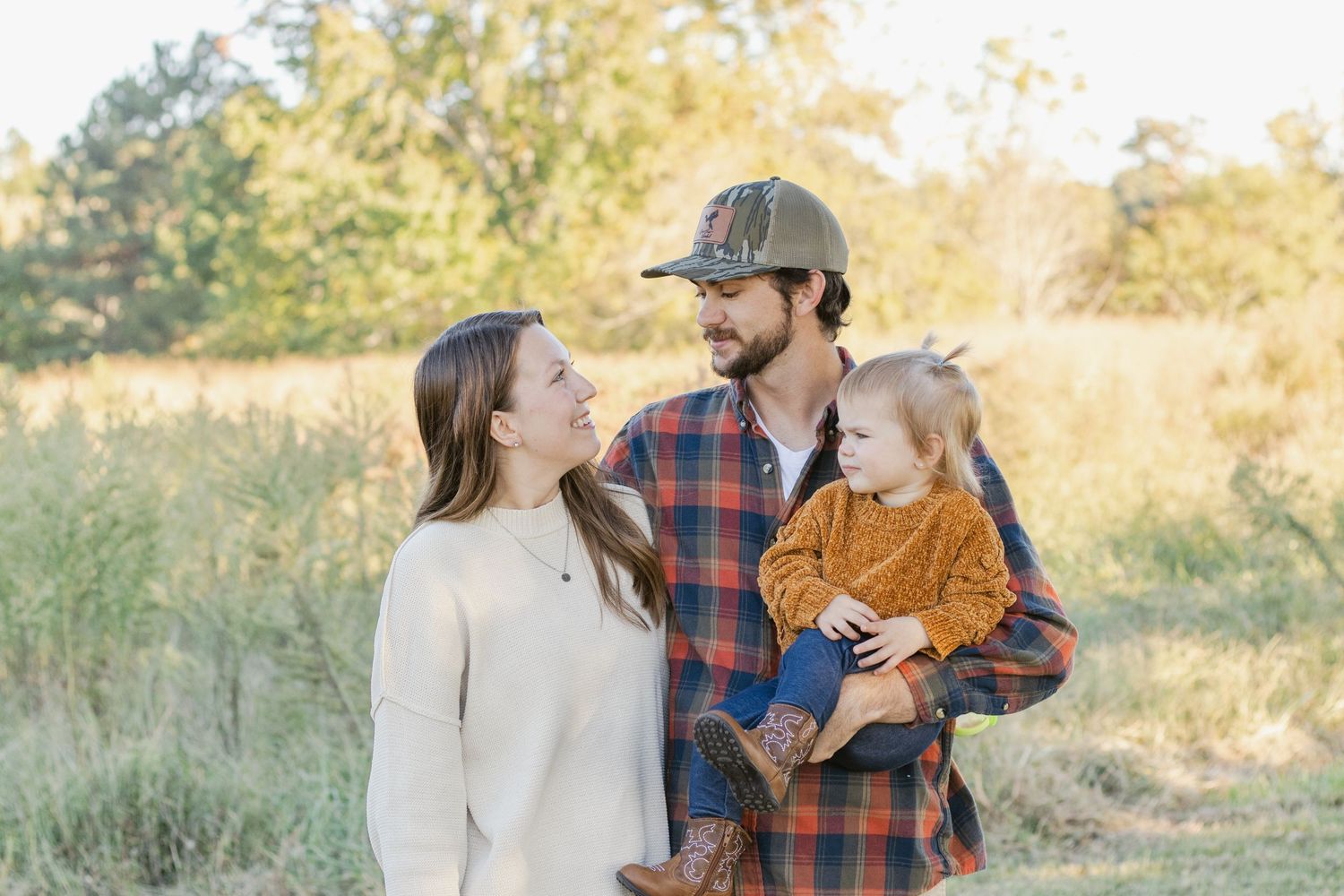 Family sharing a tender moment together outdoors in autumn.