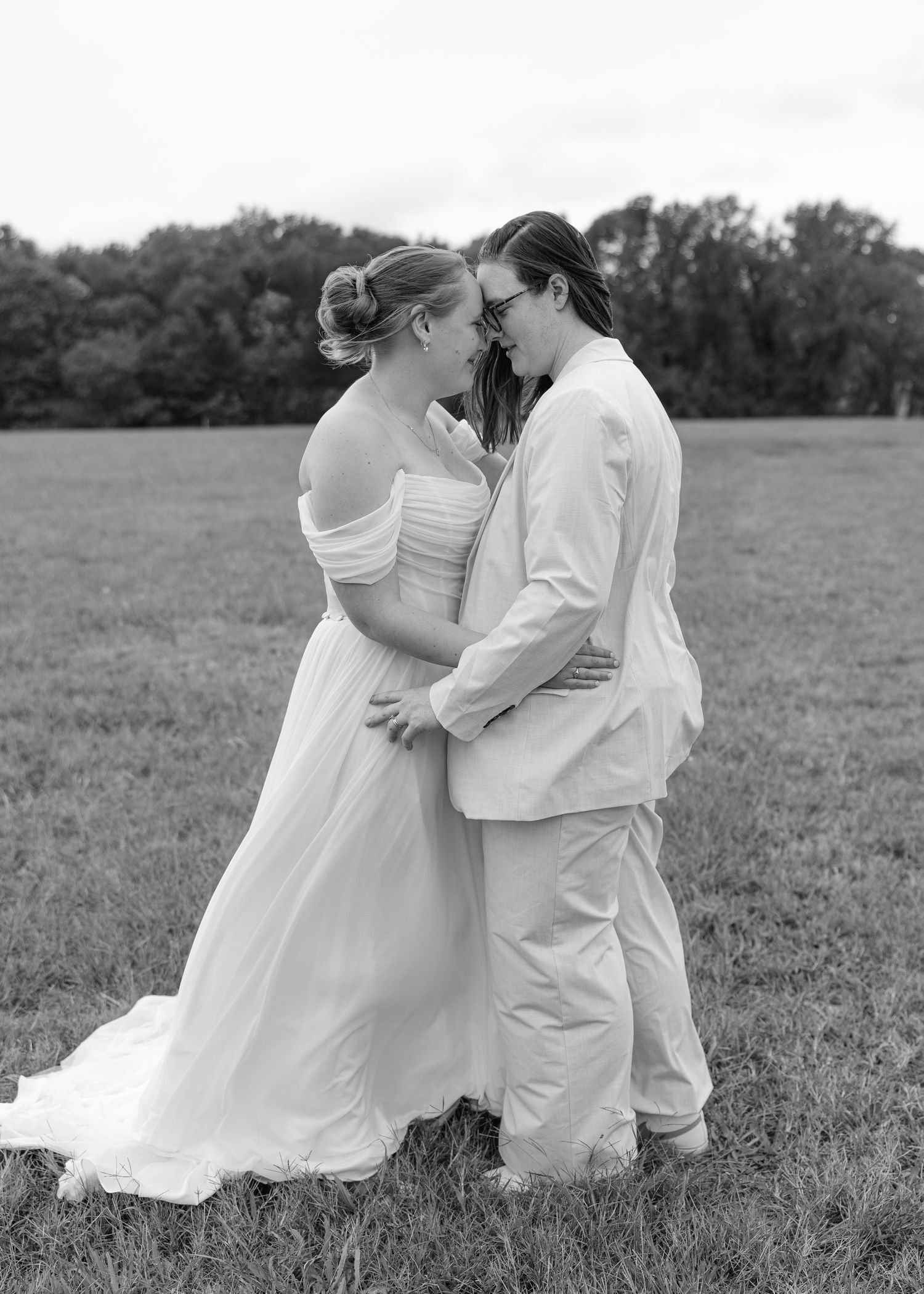 A romantic black and white photo sequence shows a couple in wedding attire dancing together in a grassy field.