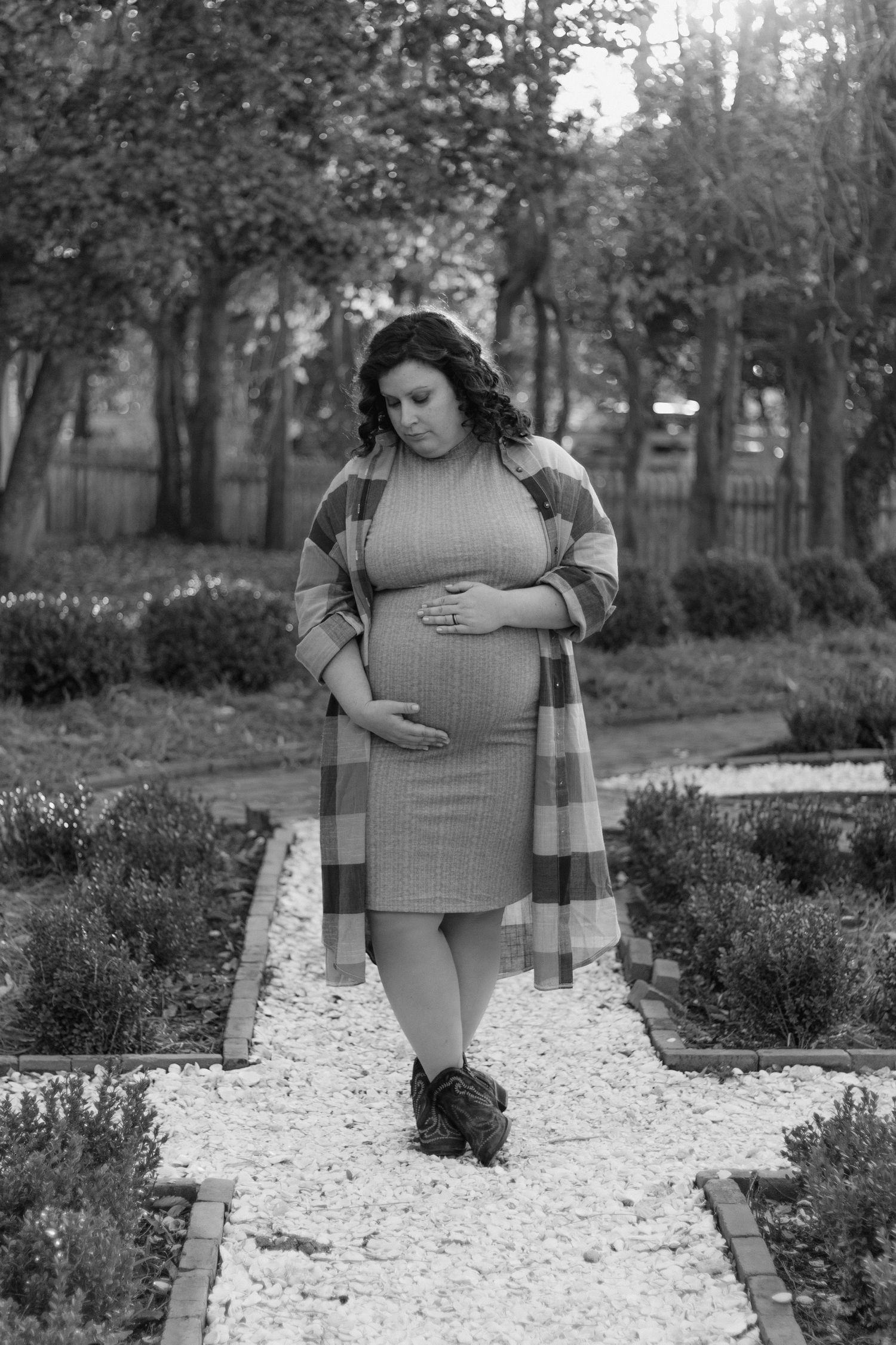 A grayscale photo sequence shows someone in casual attire walking along a stone garden path through landscaped shrubs.