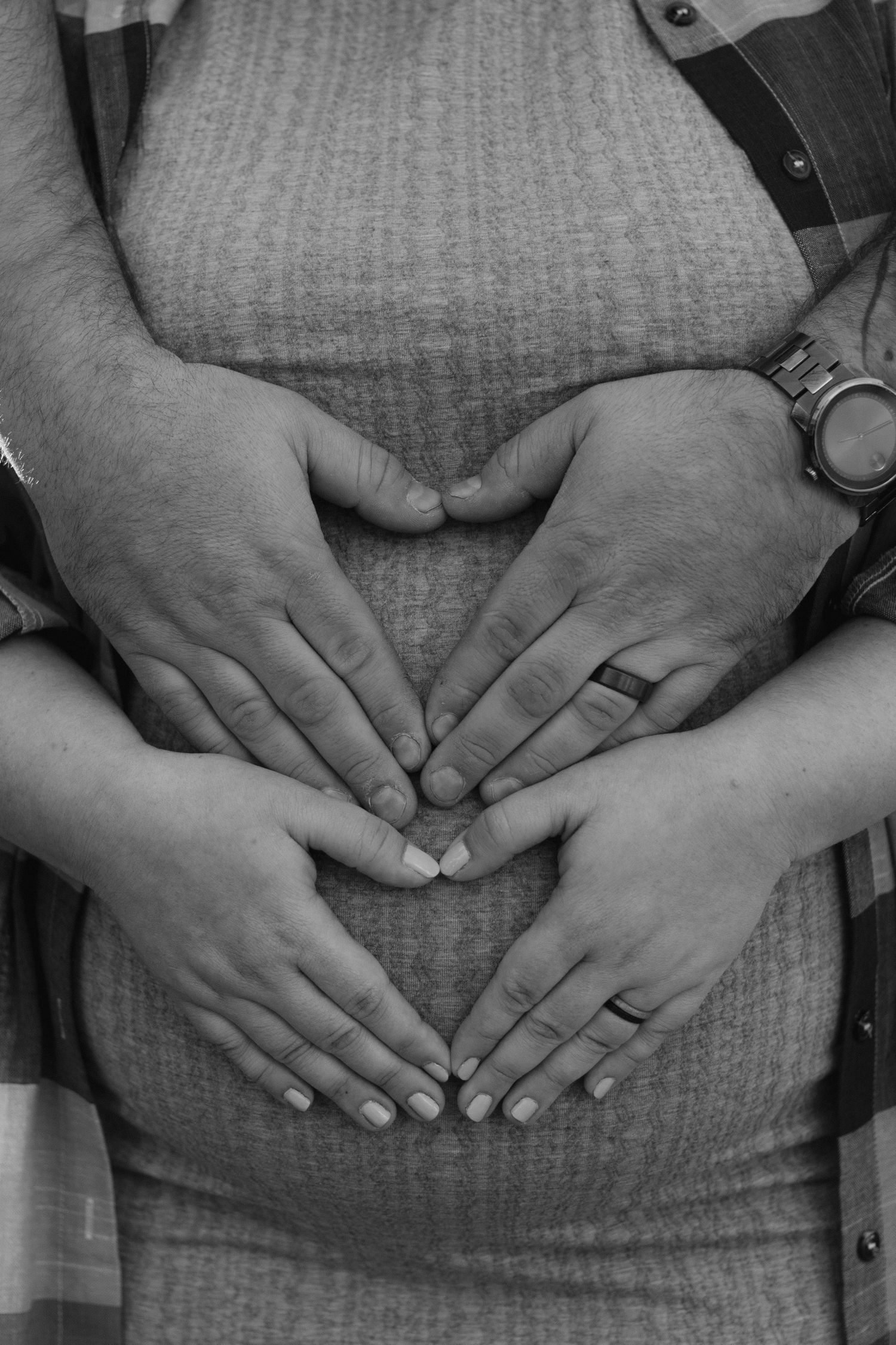 A series of black and white close-up photographs showing hands clasped together over grey fabric.